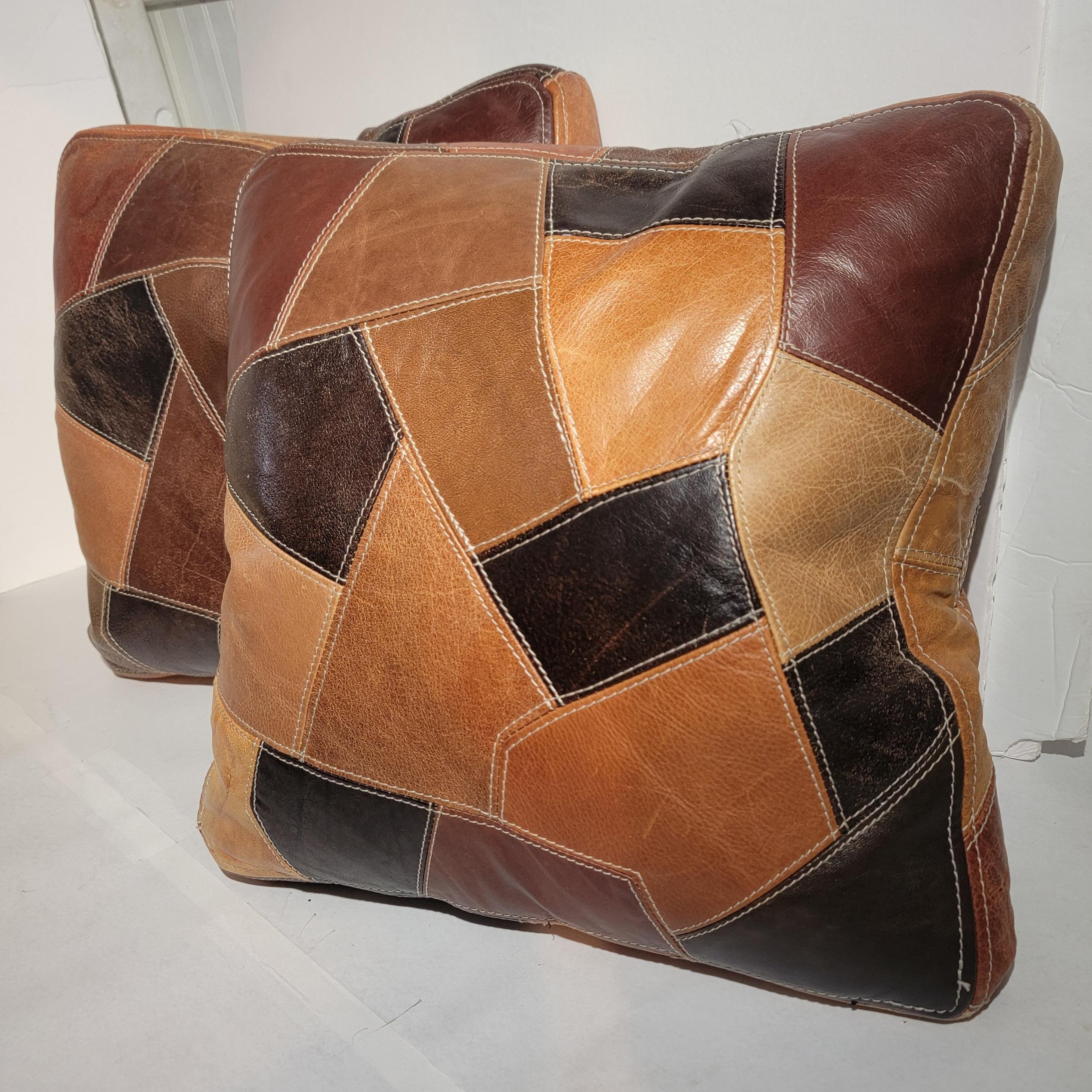 20Thc Quilted leather cushions in fine condition and double sided.Down & feather fill inserts.These are vintage cushions from the 1940's.The condition are very good.