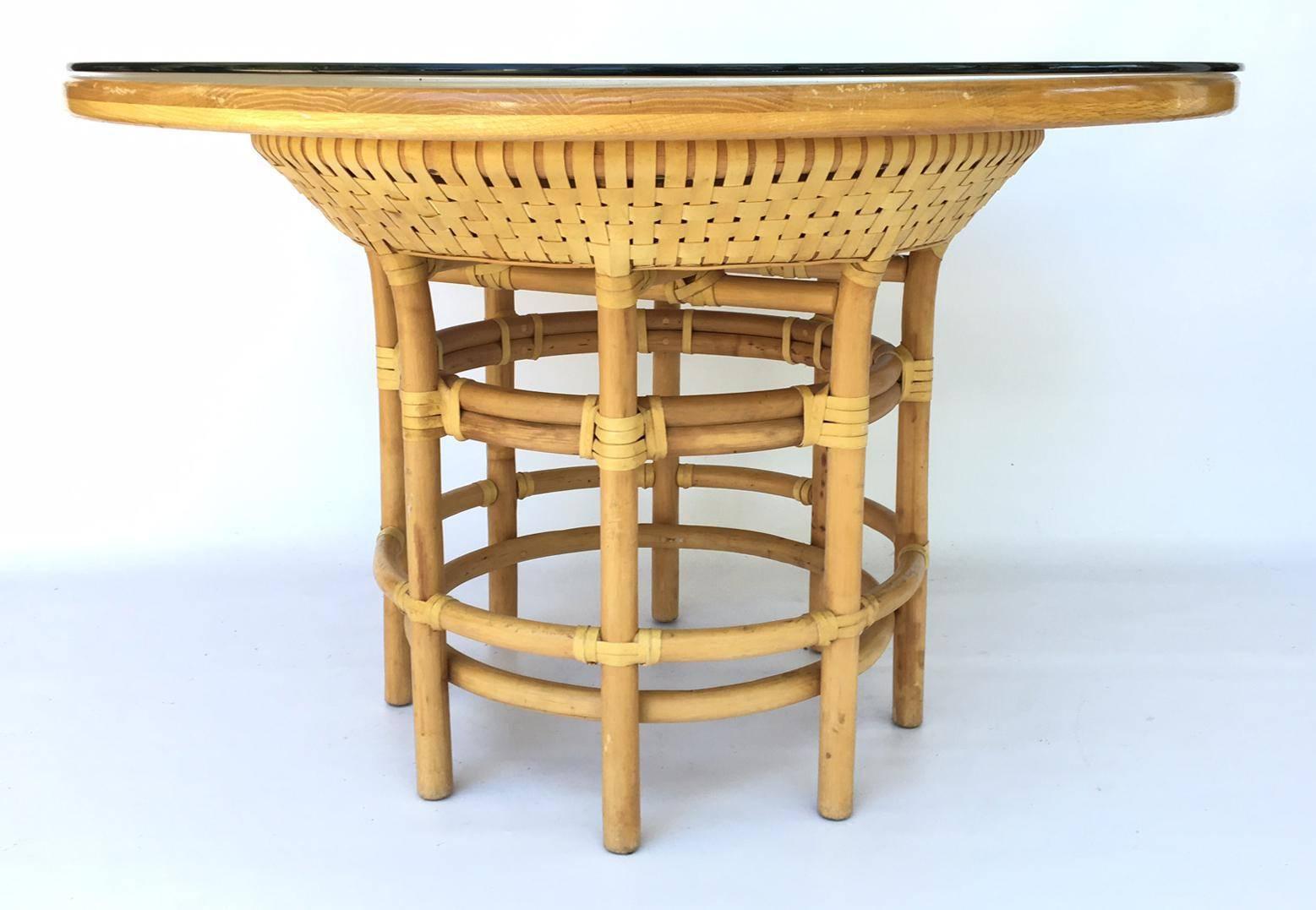Leather-wrapped rattan base dining table with round solid wood top. Removable 48