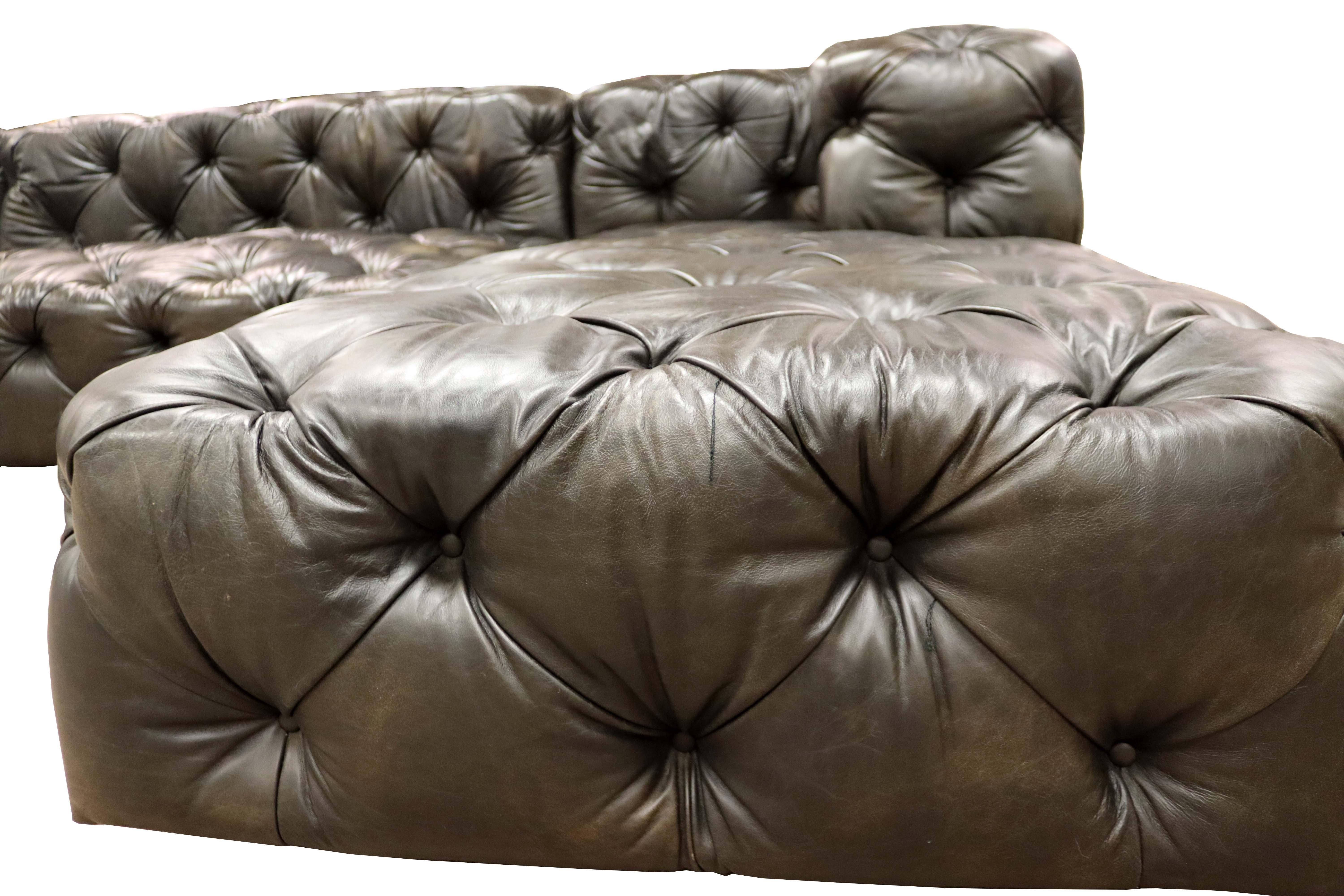 Grandly proportioned with a low profile, this sectional with chaise is lavishly detailed with all over button tufted in a soft brown-black leather. Squared off arms give this fantastic seating a contemporary yet traditional vibe, suited to most