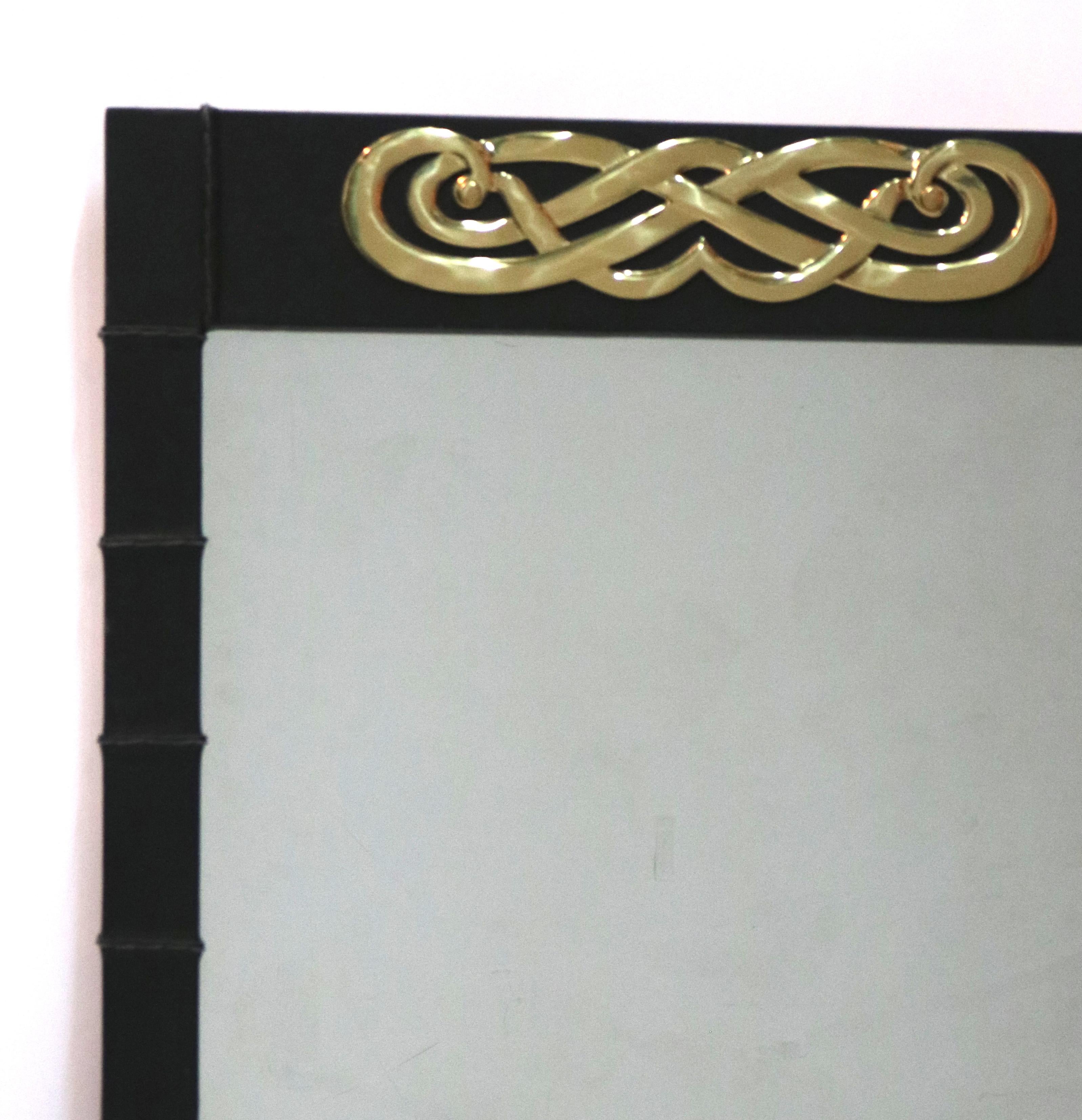 Mid-Century Modern gorgeous rib stitched design leather wrapped wood mirror with a polished brass medallion centered on the top area.

Measures: 24 1/2' W x 36