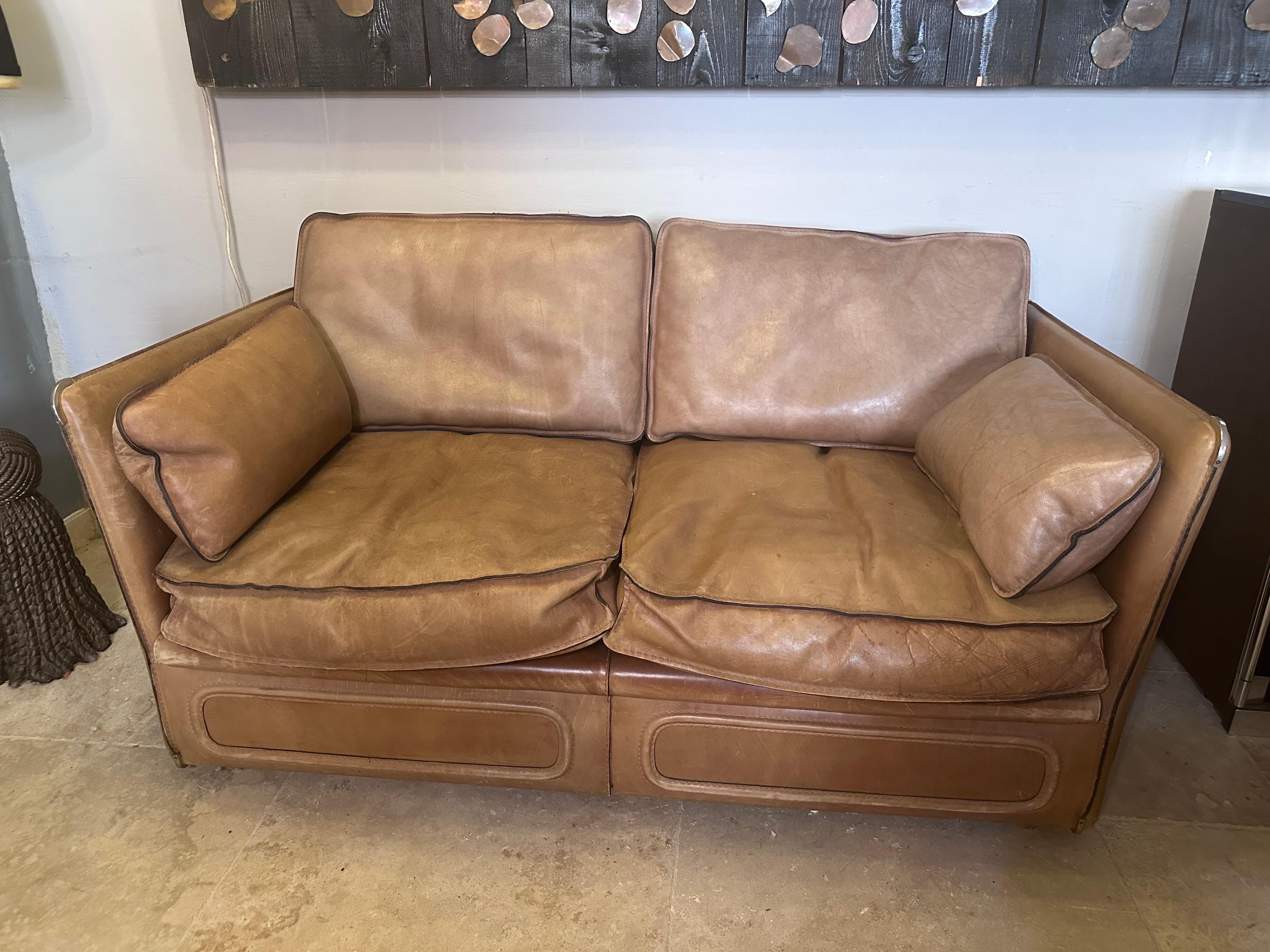 Roche Bobois leather 2 seaters sofa from the seventies.
Thick buffalo leather, brass corners, feathers cushions, saddle stitching, wooden legs... 
Great quality and condition for this rare sofa.
Pair available.
