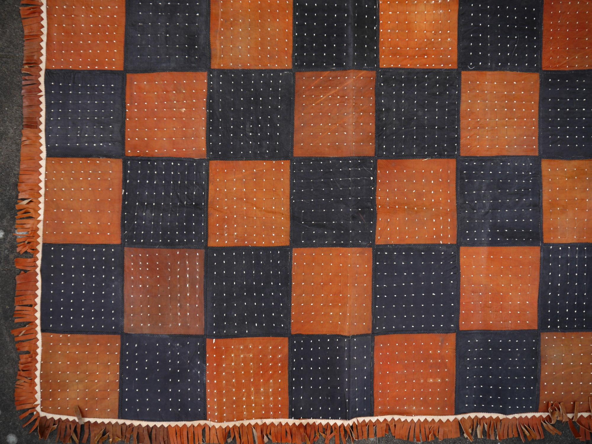 Leather rug checkerboard patchwork black brown Tuareg carpet from Mauretania

A beautiful rug from Mauretania.
• Beautiful colors, very vibrant
• Made of soft goat leather
• Patchwork
• Traditional design, goes well with midcentury, Art Deco,
