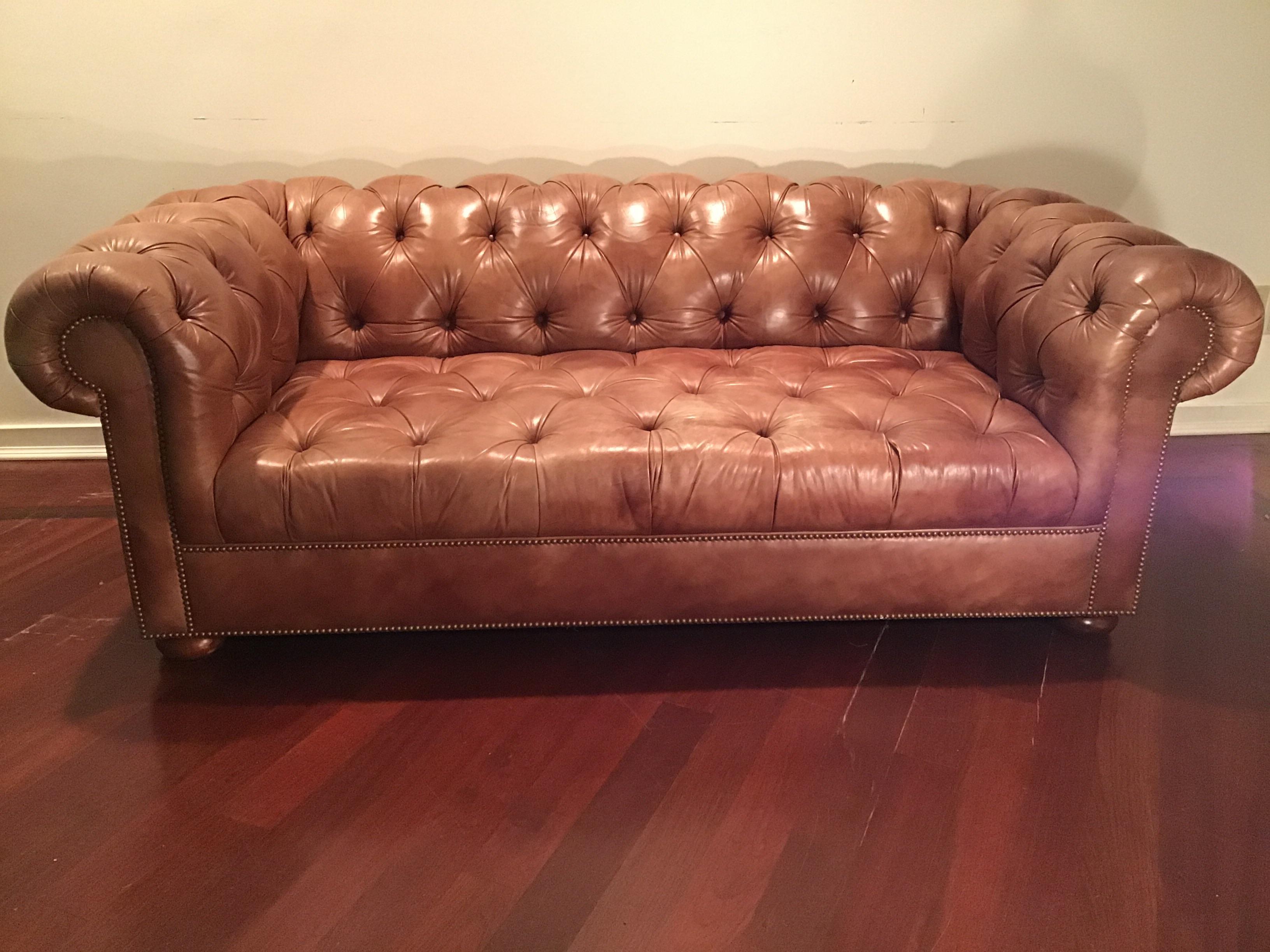 High quality, very heavy, leather Chesterfield sofa on wooden feet. Very deep.
Saddle color. From a Southampton, NY estate.