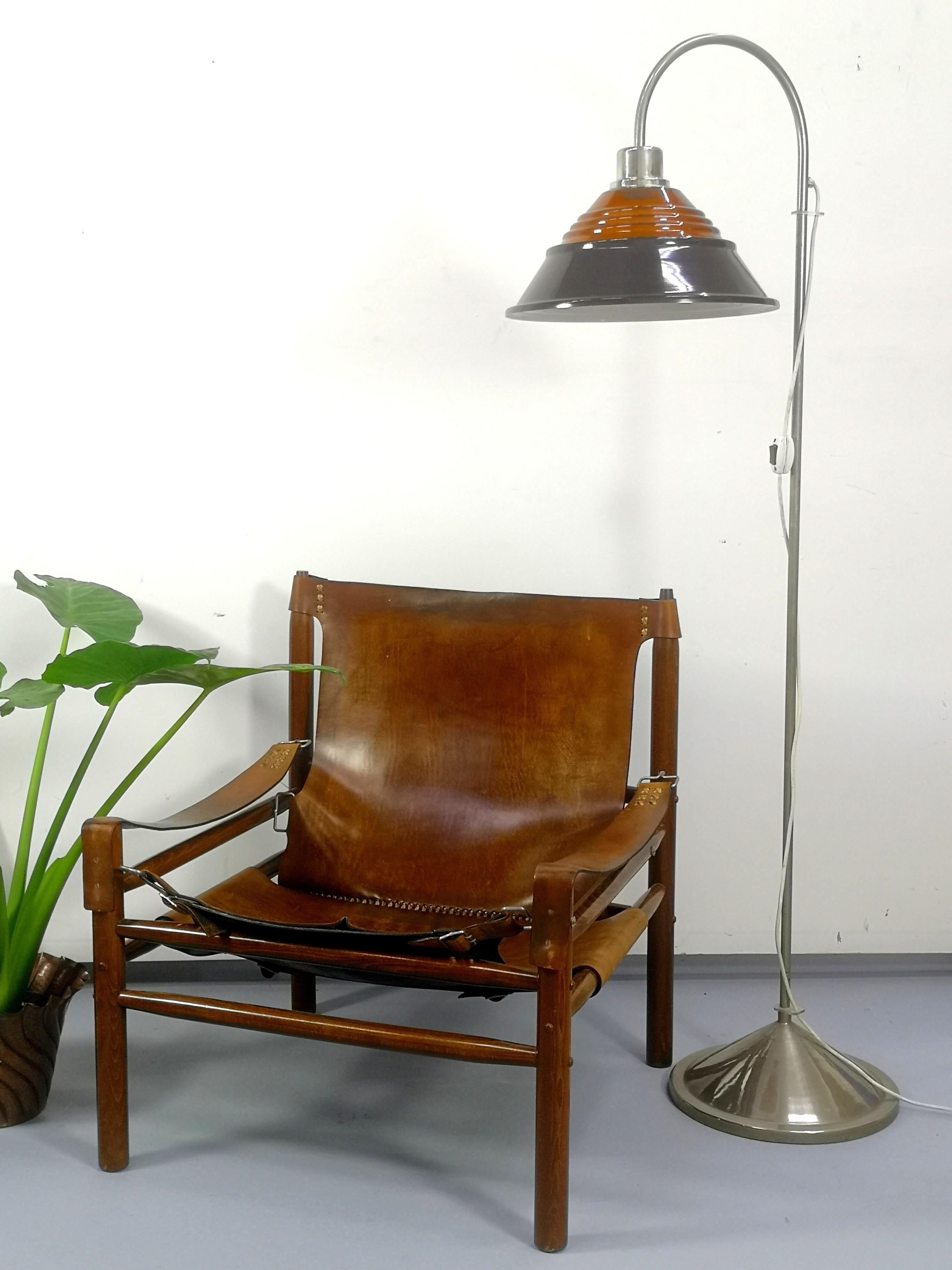 This sturdy raw leather and solid wooden armchair was made and designed in the 1970s.
  
