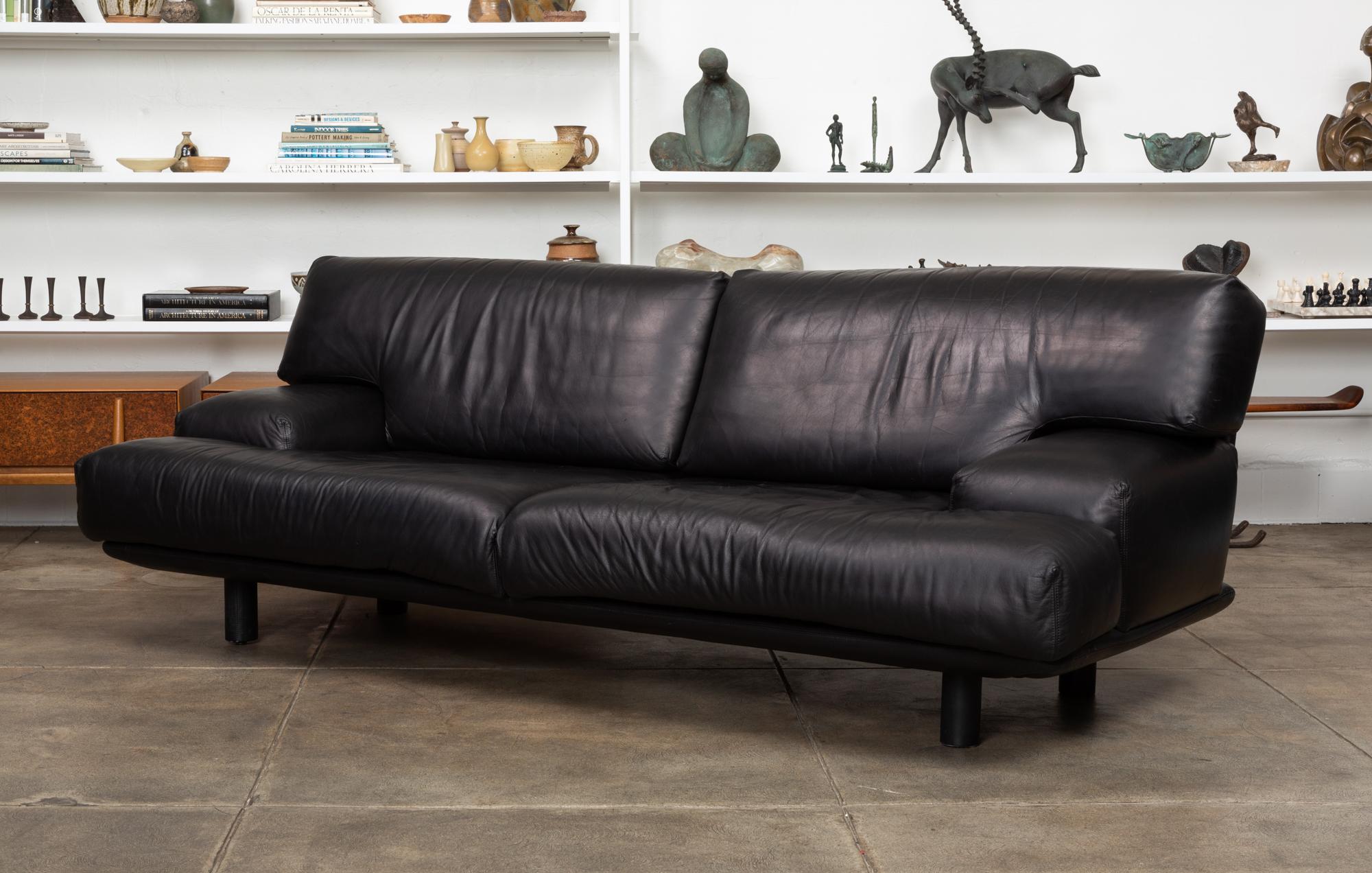 Black leather sofa by Brayton International, USA, circa 1980s. The sofa features a Minimalist low profile with wide sumptuous cushions and armrests, all upholstered in a soft black leather. The cushions sit atop an upholstered leather frame with