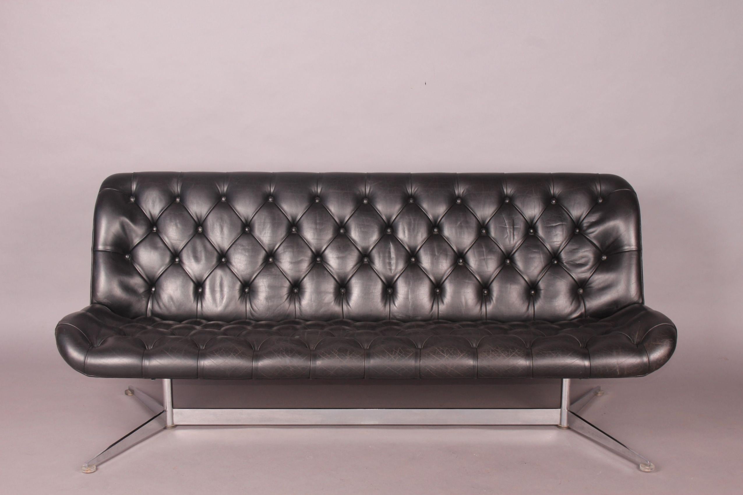 Black leather sofa, small damage on the side (photo).