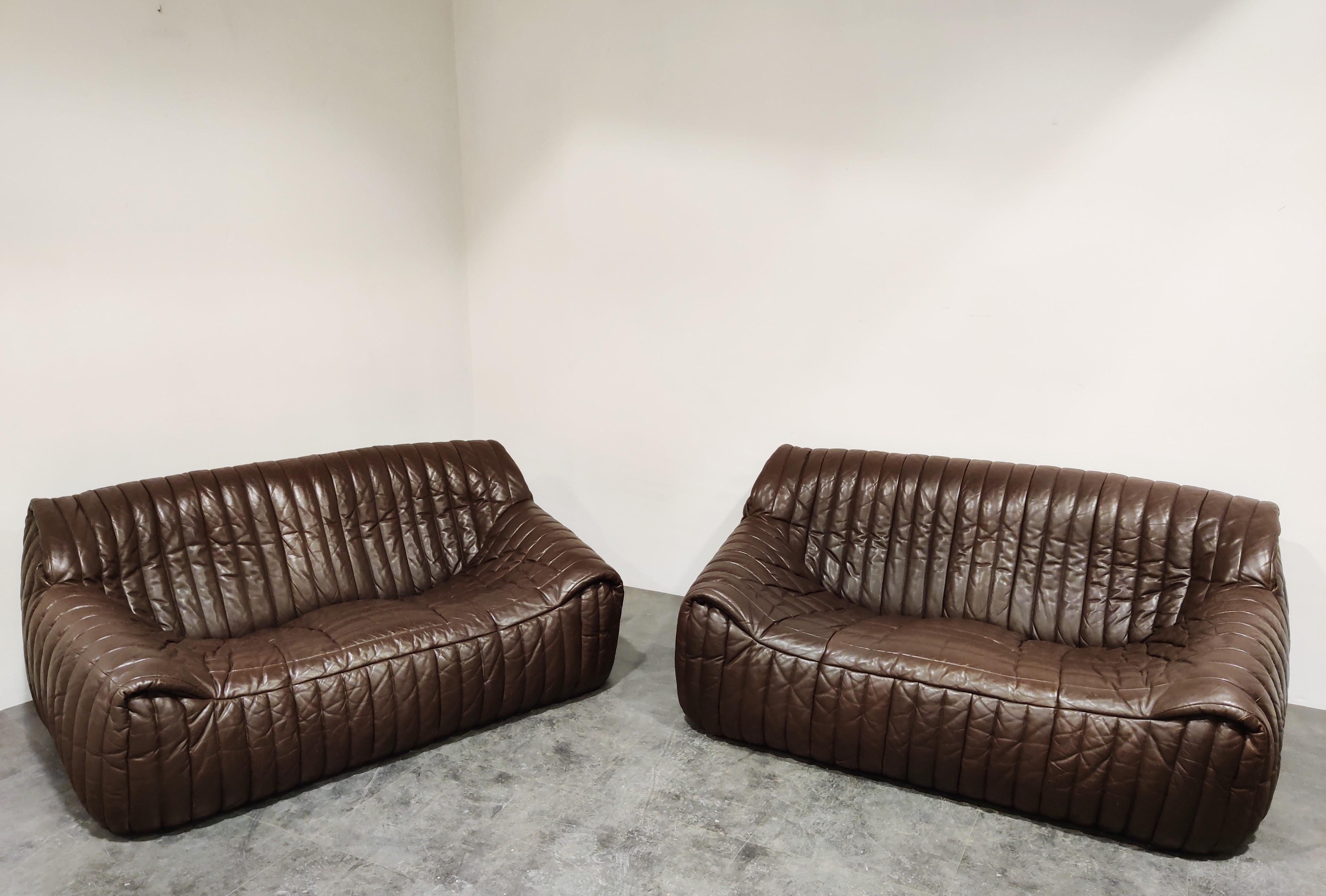 Pair of vintage chocolate brown leather sofa's designed by Annie Hieronimus for Cinna.

Great organic design, very much like the Togo sofa.

They are comfortable and look very timeless.

Very good condition.

The sofas come with two extra