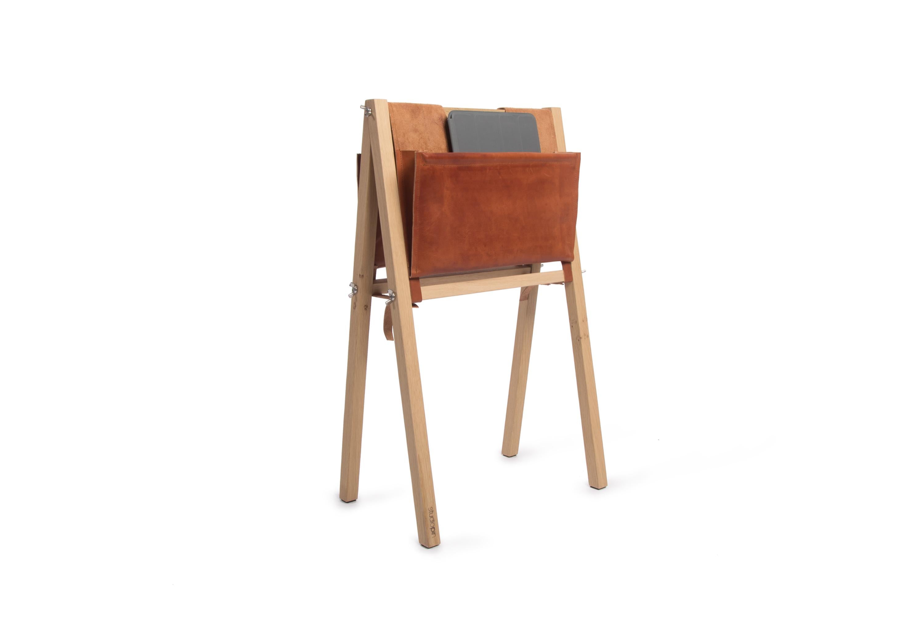 Leather Stan Magazine Rack by Studio Pin
Dimensions: W 42 x D 26 x H 67.2 cm
Materials: solid oak, leather.
Weight: 2.5 Kg.

Stan is a magazine rack. The oak frame perfectly matches the 3 types of bags in the colors light brown and dark grey of