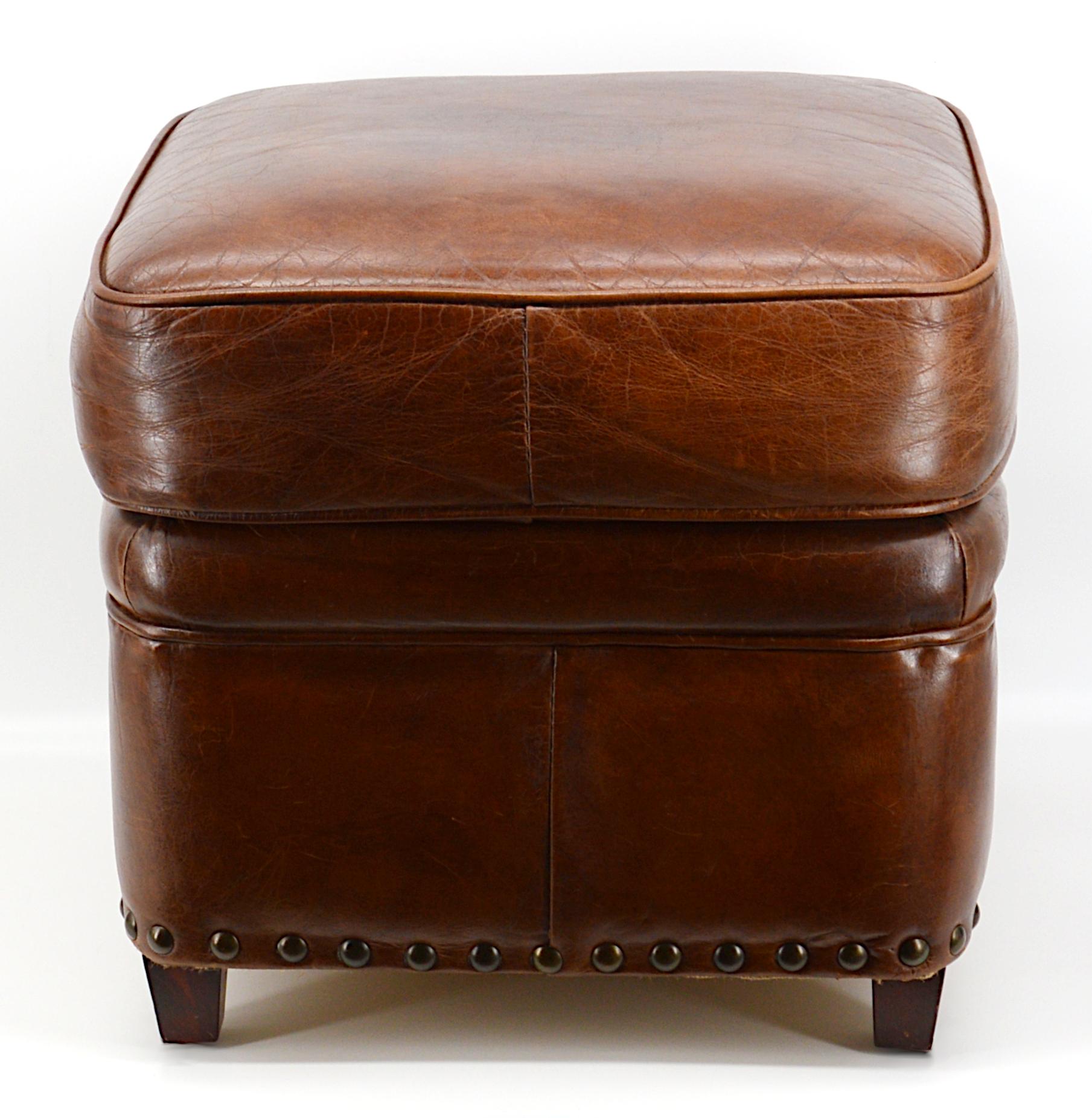 Modern stool bench upholstered with leather. Four wooden feet. Beautiful patina.
