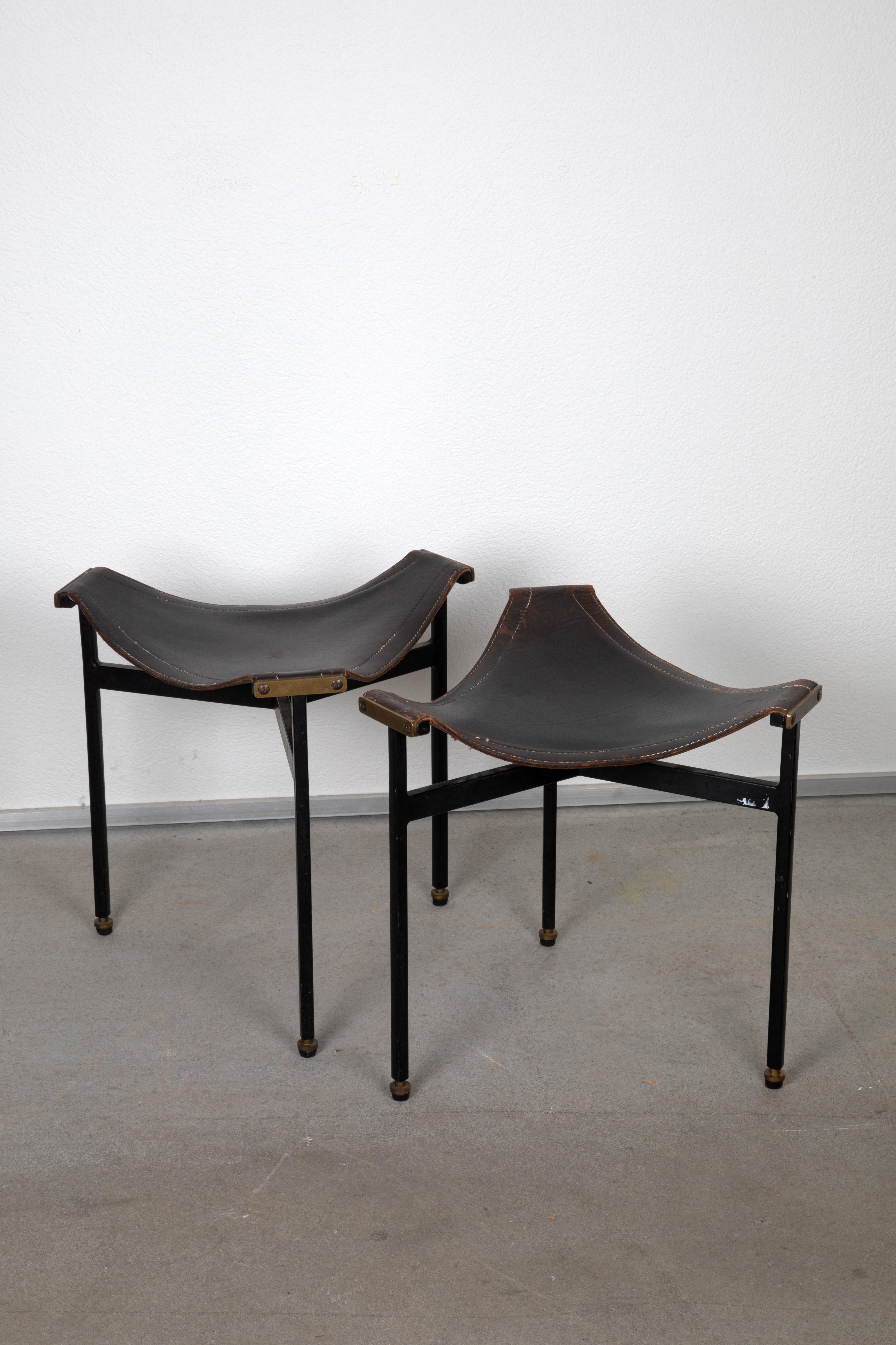 These Leather Stools, crafted in the 1950s, exemplify a blend of functional design and luxurious materials. The stools feature saddle-stitched leather, known for its durability and sophisticated aesthetic, paired with black lacquered metal legs and