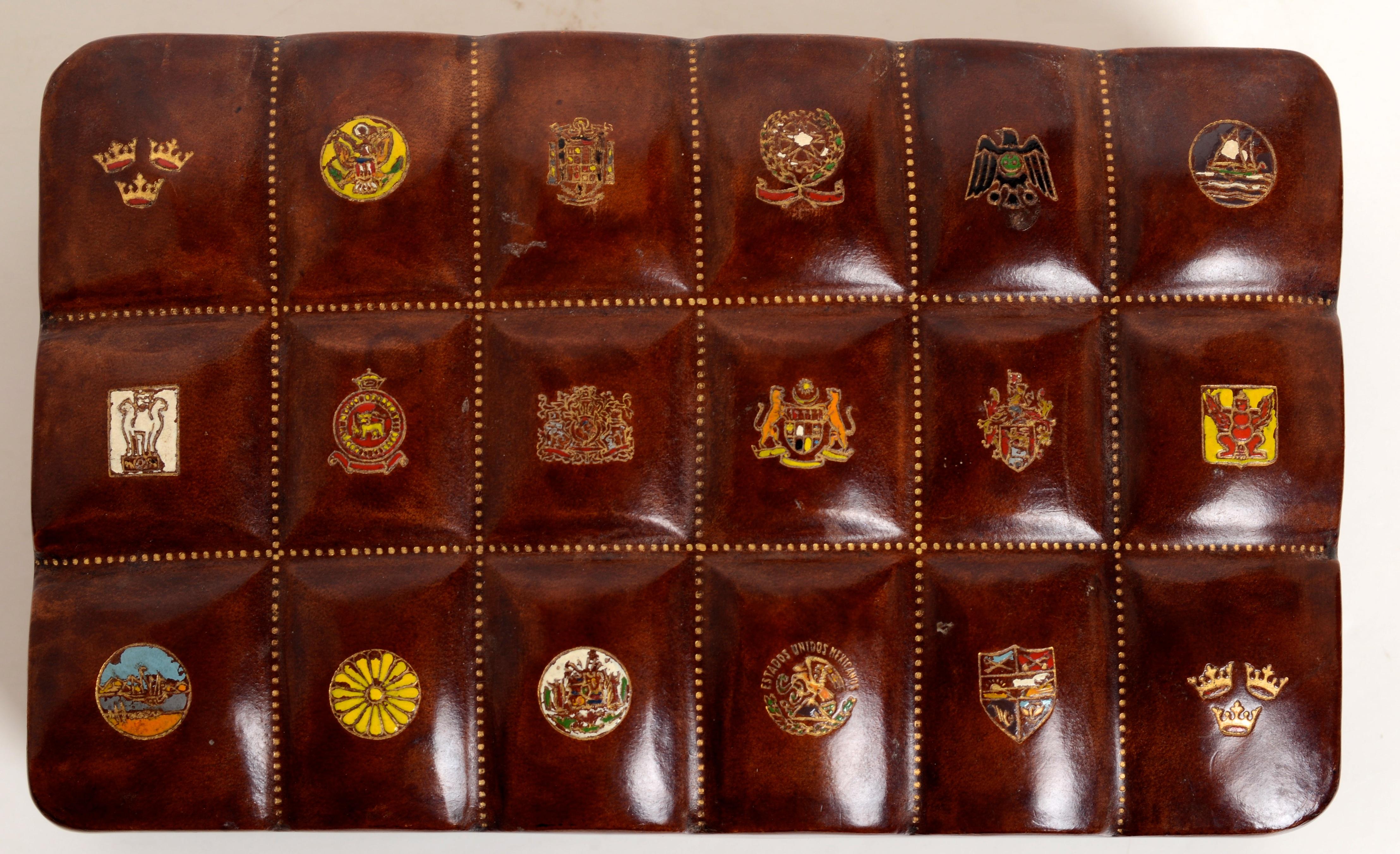 Leather Swedish American Line Jewelry Dresser Box, c1950. The top with 18 raised rectangles each embossed with a different colored Swedish armorial cartouches signifying the ports of call that the Swedish American Steamship Line serviced.. The