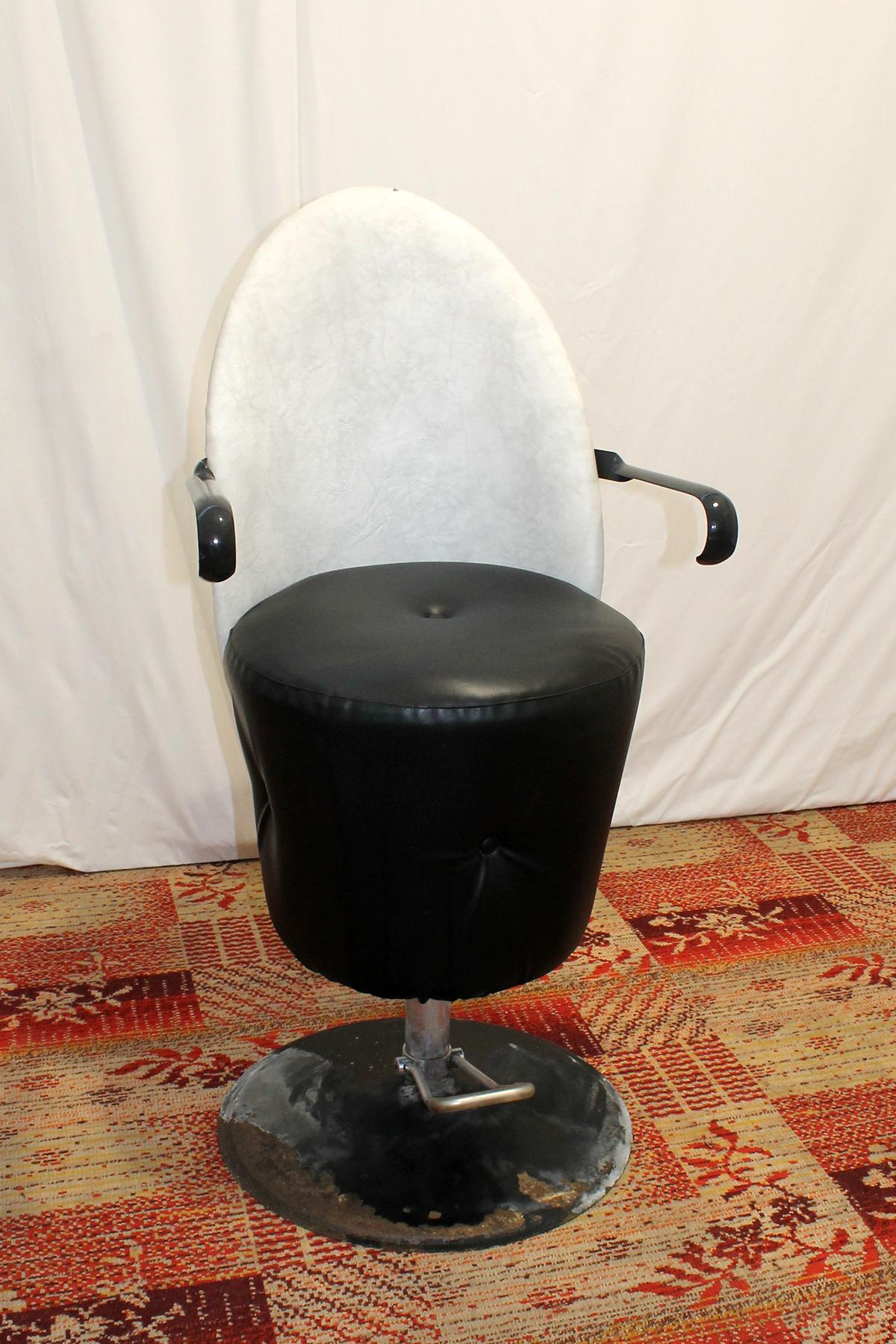 Vintage Leather swivel hairdressing salon chair from the 1980's. It was made in the former Czechoslovakia and used in a hair salon.
The armchair is functional, the hydraulics are working, and the seat with backrest has the ability to move. The