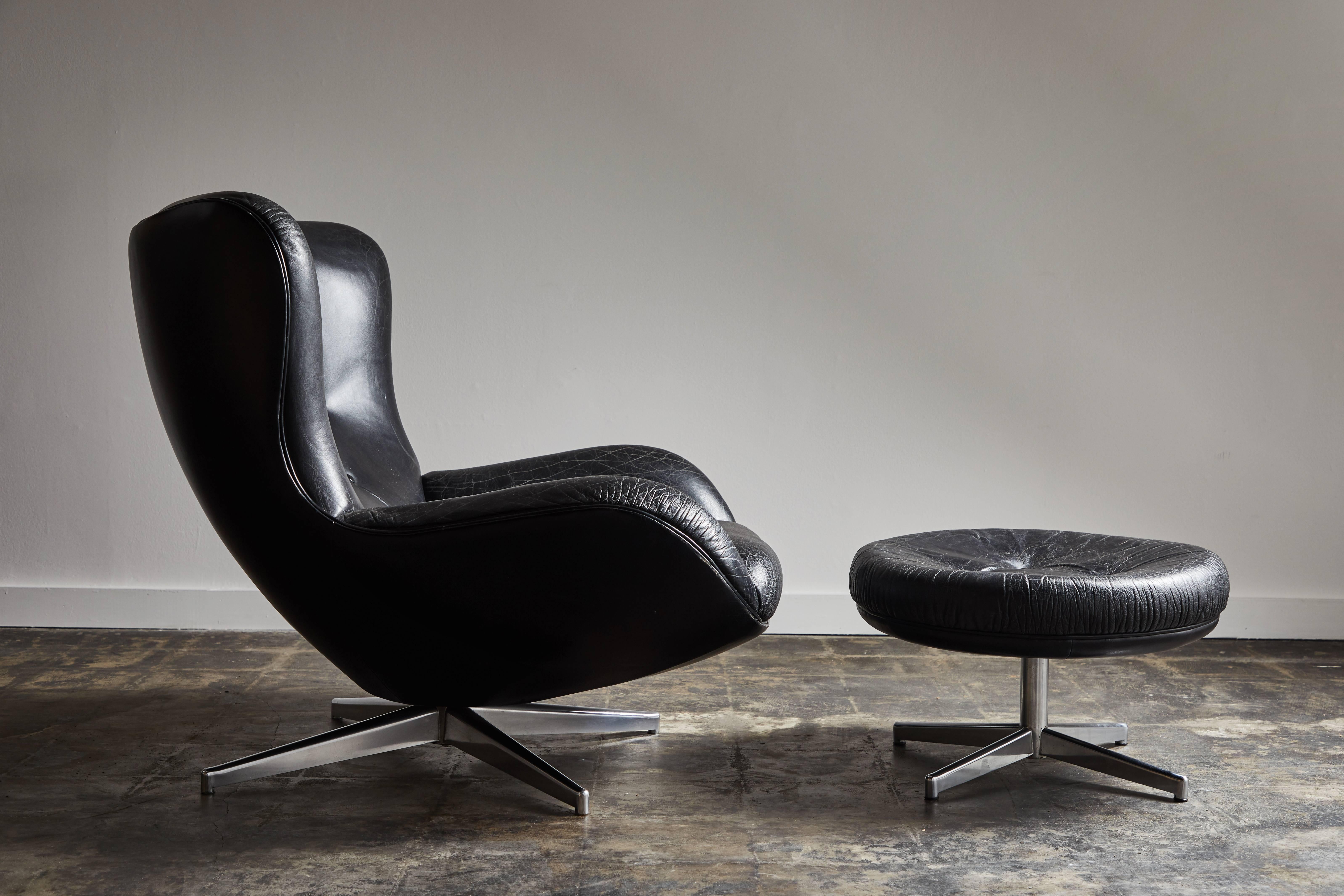 Black patinated leather lounge chair and ottoman Model ML 214 by Illum Wikkelsø. Made in Denmark, circa 1960s.
 