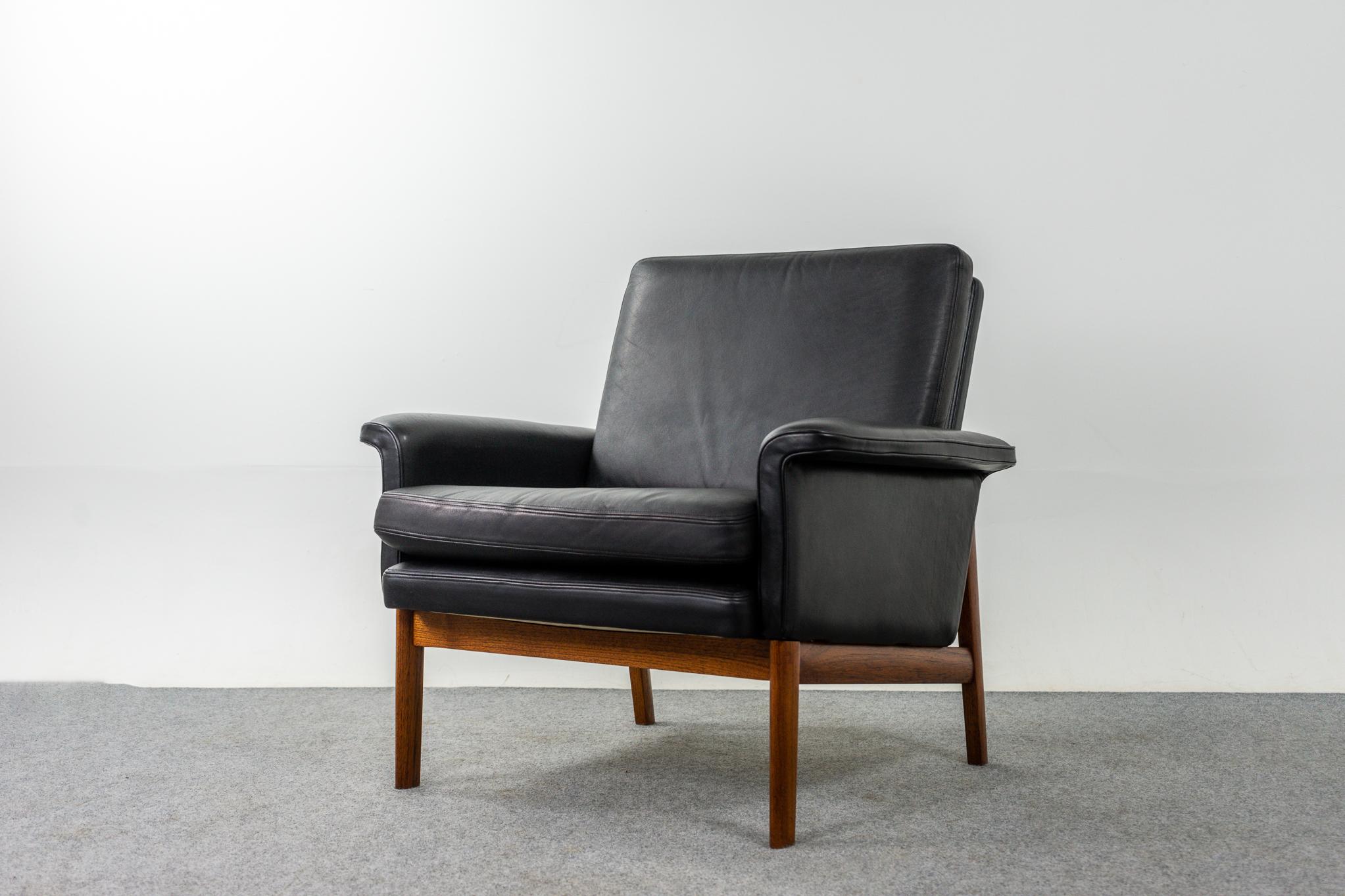 Leather and teak Danish model 218 Jupiter chair by Finn Juhl for France & Son, circa 1960's. Iconic chair features beautiful pitch black leather with perfect patina. Elegant teak base contrasts beautifully with the upholstery. Perfectly angled for