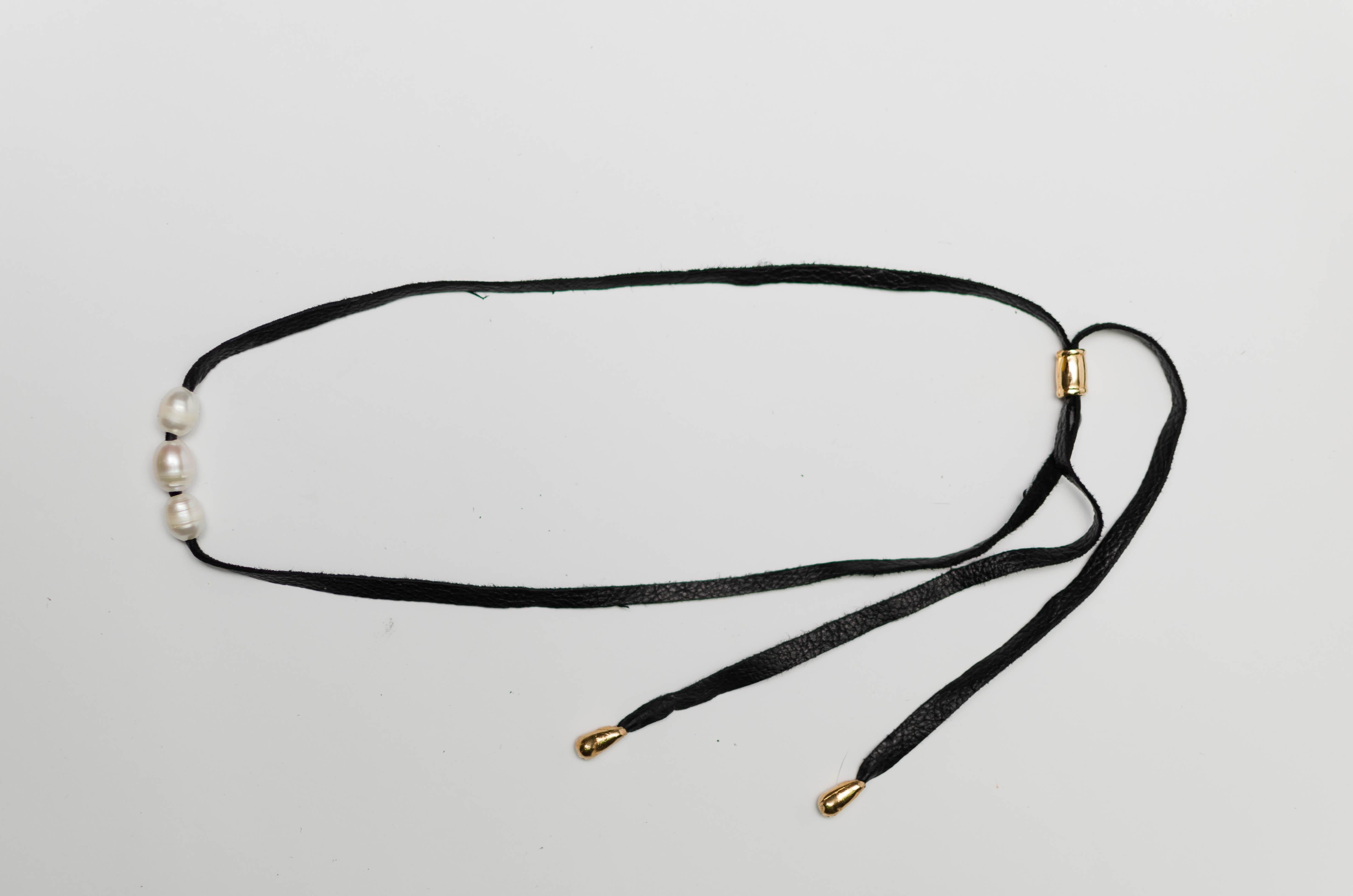 These pieces were designed, hand-carved, and then cast from our workshop in Uruguay.
Delicate necklace with three carefully threaded cultured pearls on a natural leather cord with gold-plated silver terminals. 
All these processes make a truly