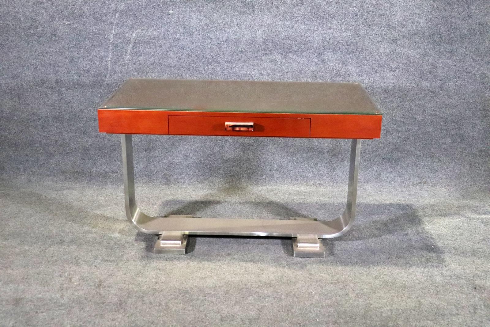 This writing desk features a leather top with glass protector on an aluminum base. Single drawer with decorative acrylic handle. Can also be used as a console table.
Please confirm location NY or NJ