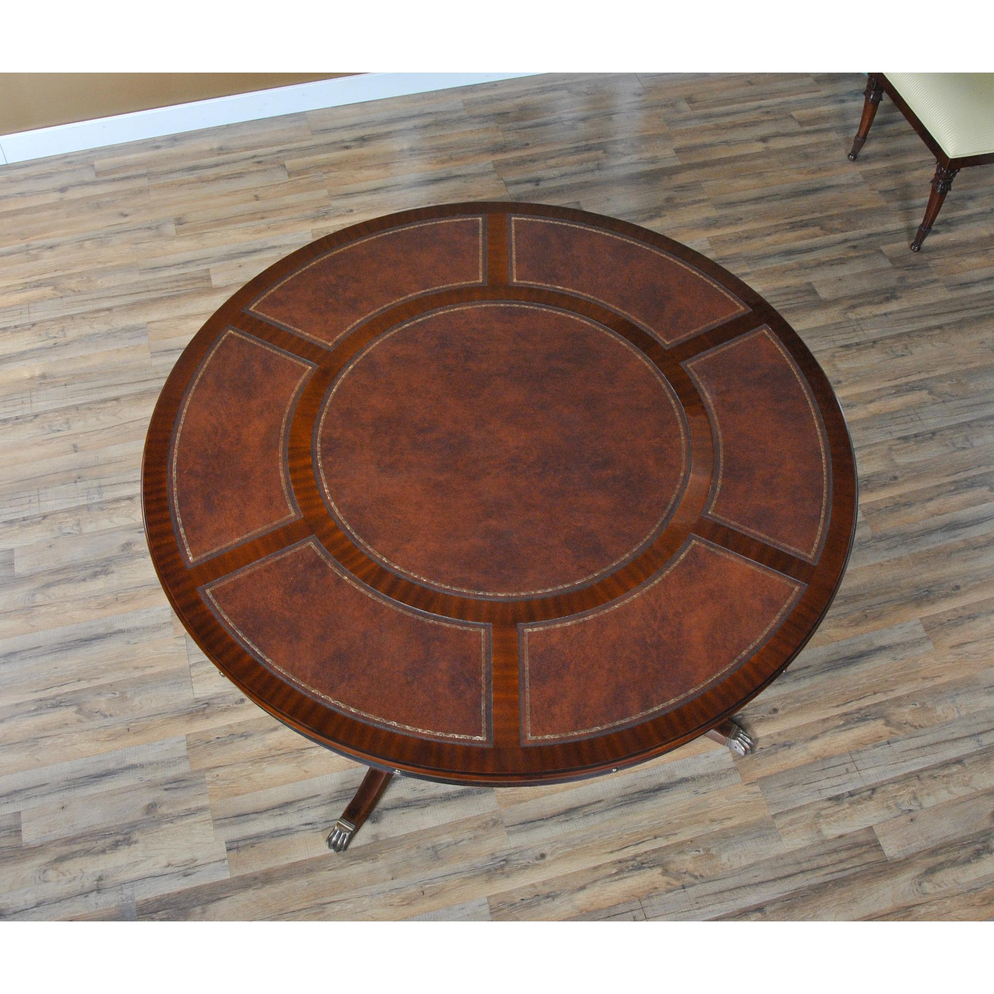 A sixty inch to eighty four inch round Leather Top Perimeter Dining Table is produced with a high quality full grain leather field and sapele banding makes for a subtle but interesting contrast in the pattern on the top. Surrounding the top can be