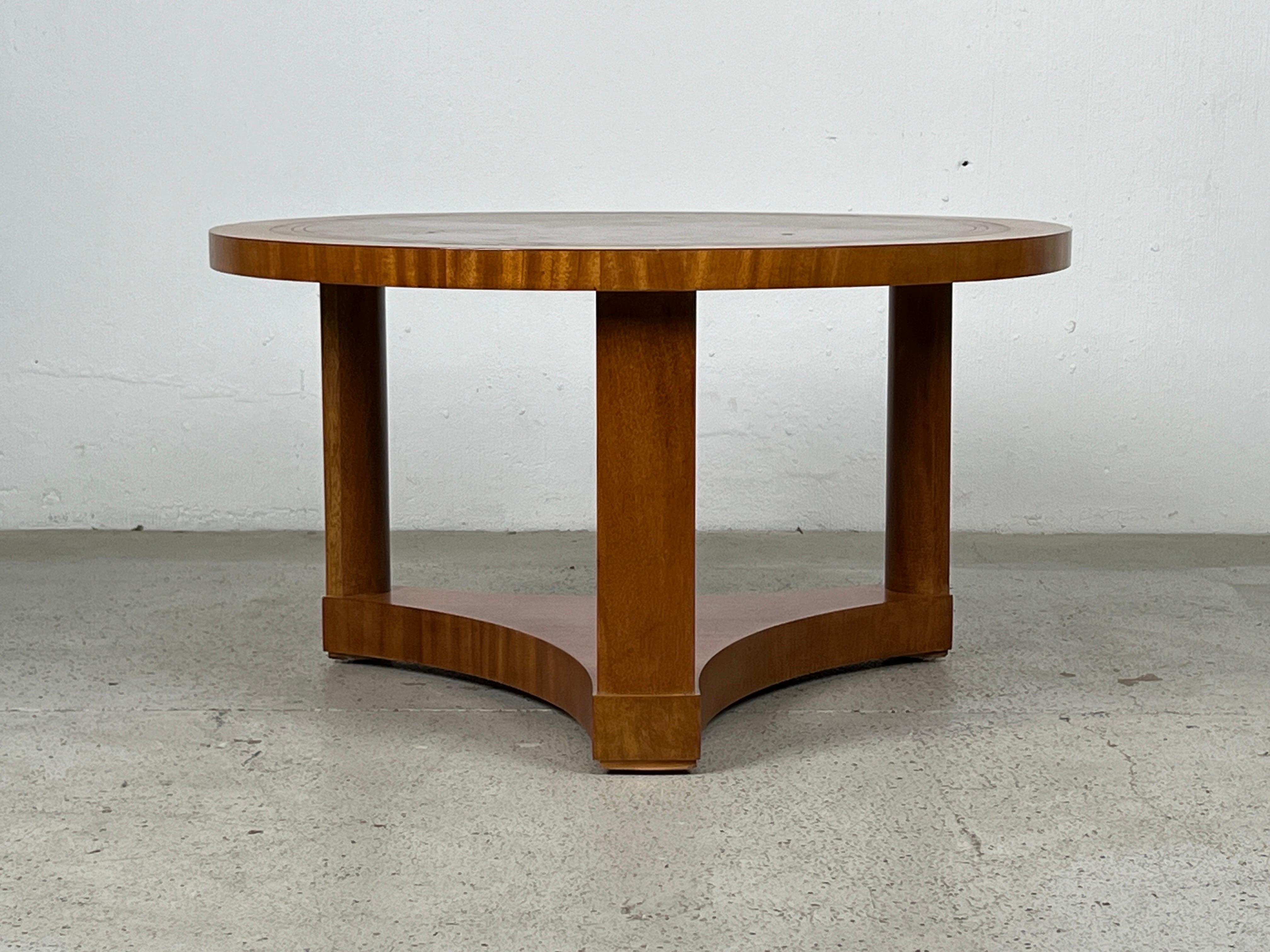 A mahogany table with inset leather top designed by Edward Wormley for Dunbar. 