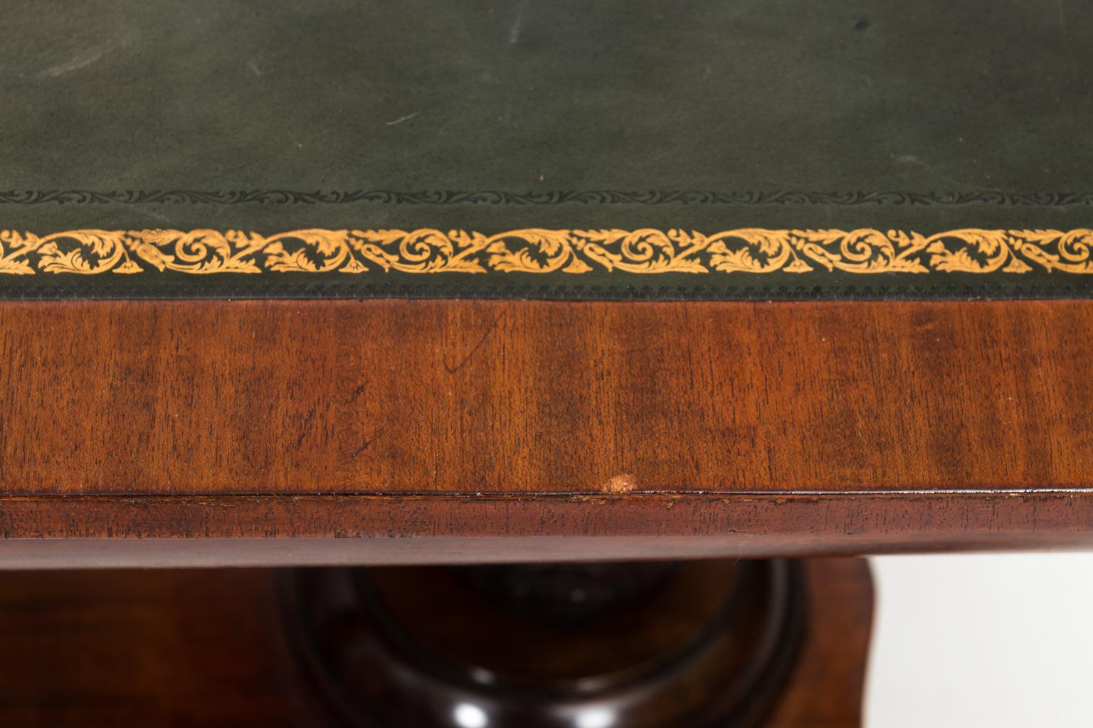 Continental style trestle base table with embossed leather top and one drawer on carved S-scroll feet, circa 1800. Please note of minor surface scratches on leather top.