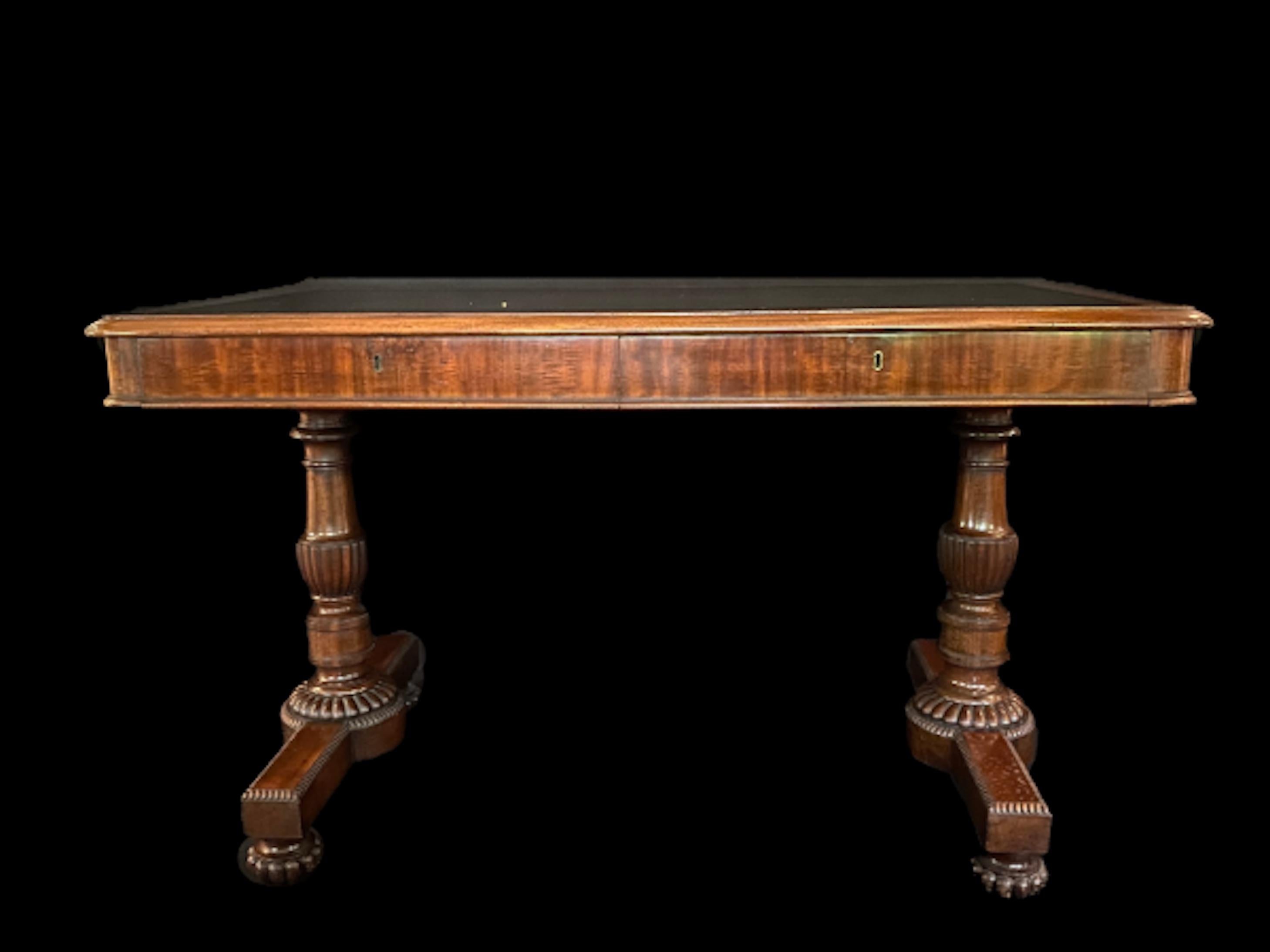 Stylish Regency mahogany centre/ breakfast table in the neo-classical manner. the mahogany is fabulous quality and the top is laid well figured green leather top, with rounded corners and a carved moulded edge, above a shallow frieze holding two
