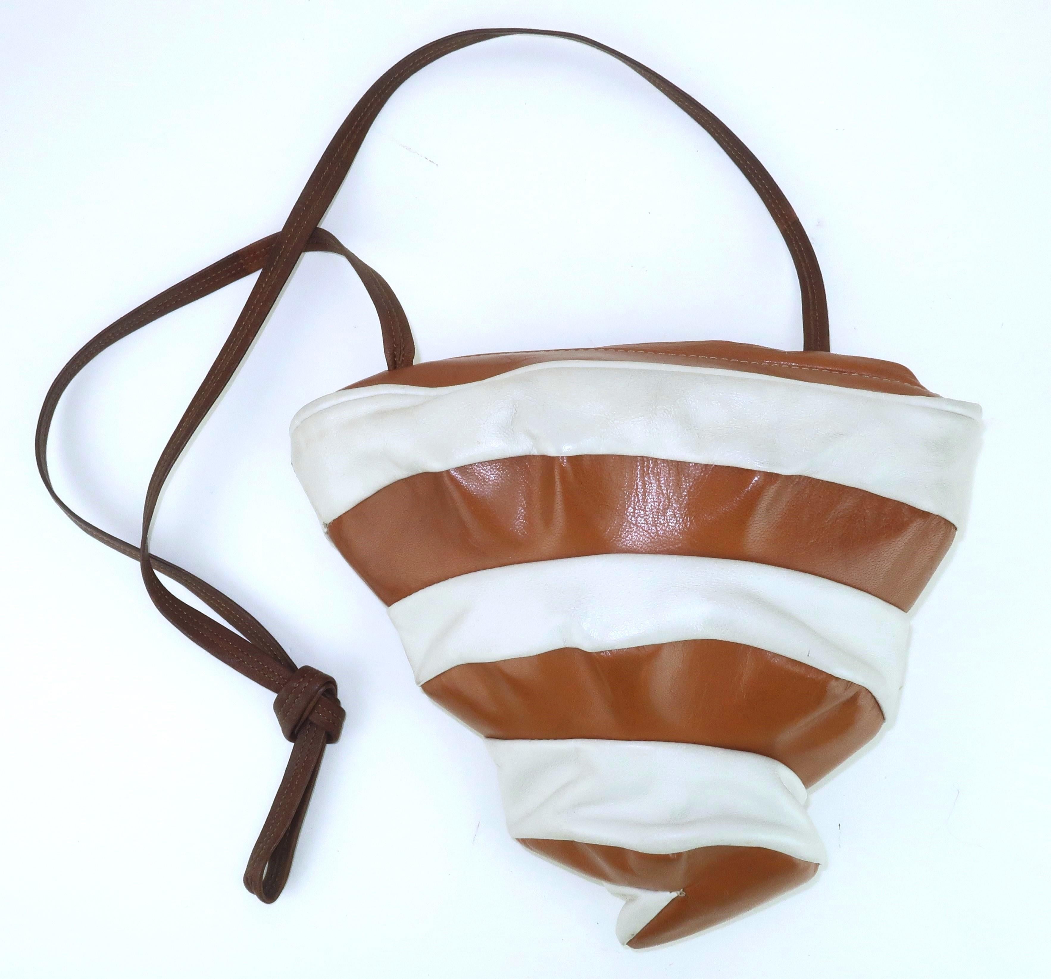 Get blown away with a terrific two-toned leather handbag shaped like a tornado (or upside down soft serve ice cream depending on your perspective).  The leather strips are in shades of camel and bone expertly stitched together to form a unique