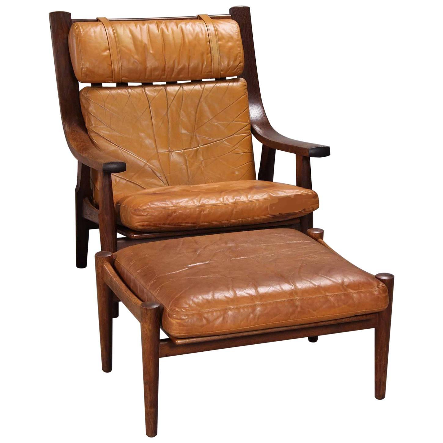 Leather Upholstered Armchair and Ottoman by Hans Wegner