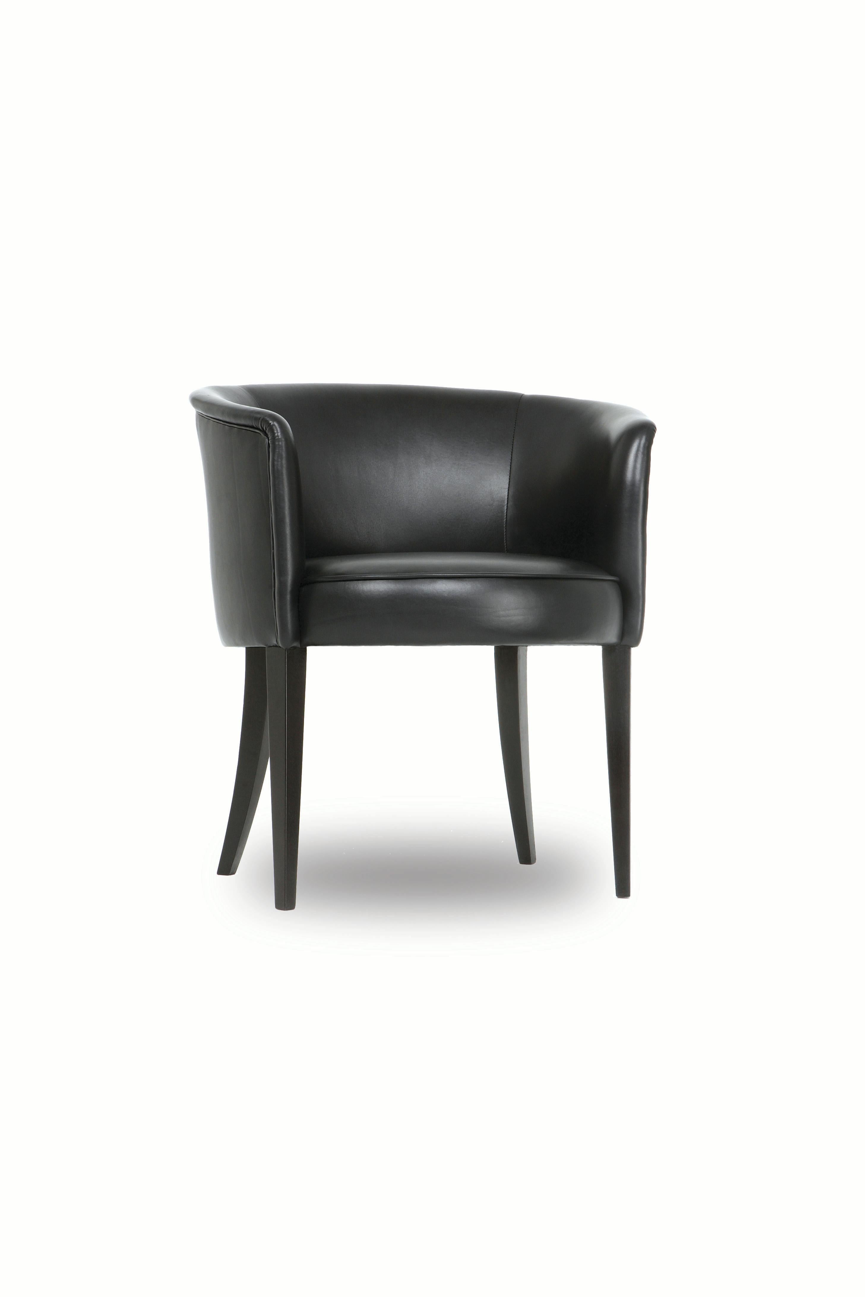 The Round chair has a tight upholstered seat and back. Seams are finished with self welts. Tapered front legs and curved back legs are made of blackened hardwood. 

Made to order and handcrafted in the USA. Available in leather in a range of colors
