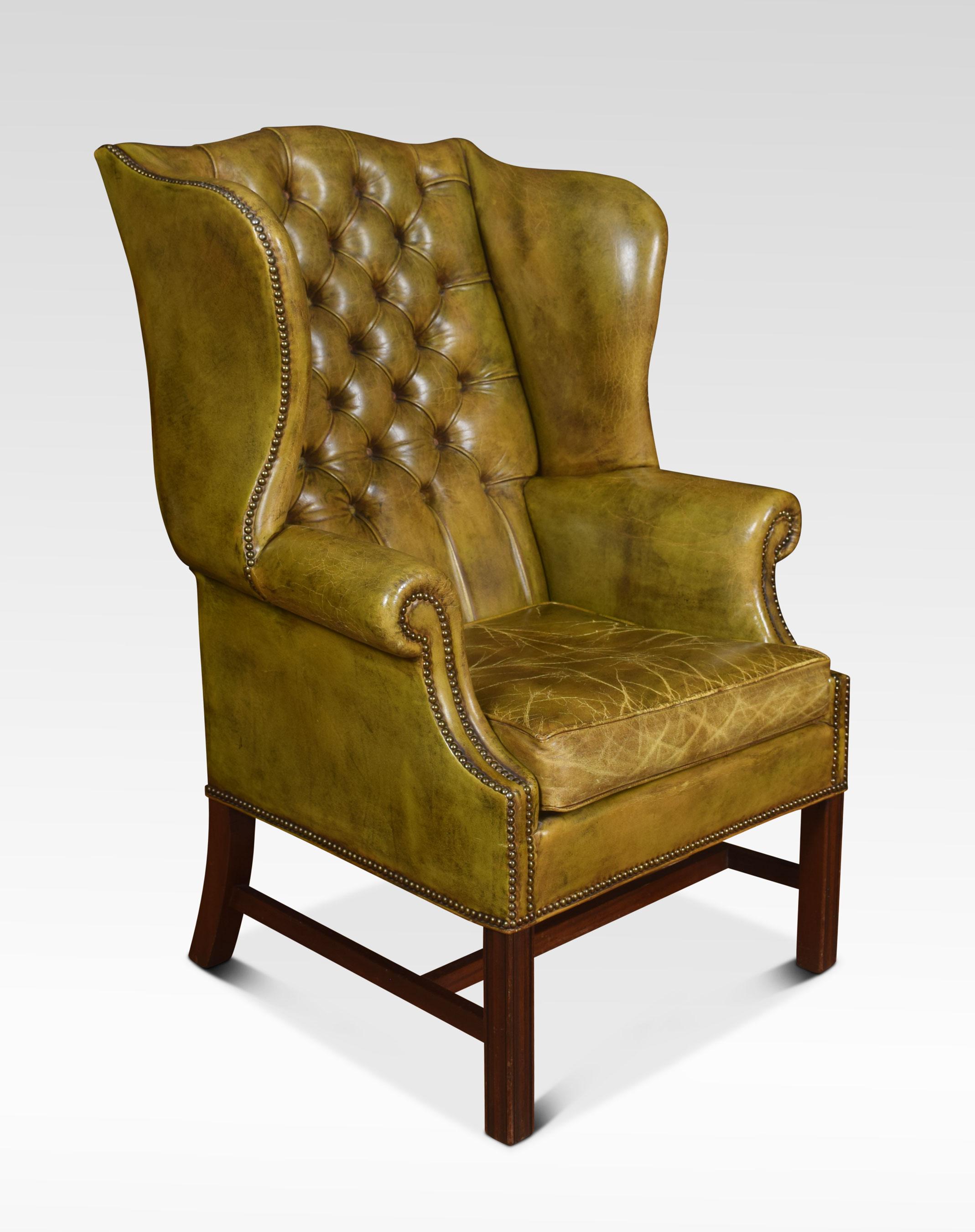 Mahogany framed wing armchair of generous proportions, the arched top above deep buttoned back, upholstered arms and seat in green leather, raised up on square supports united by a stretcher.
Dimensions
Height 47 inches height to seat 20