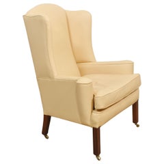 Poltrona wingback imbottita in pelle