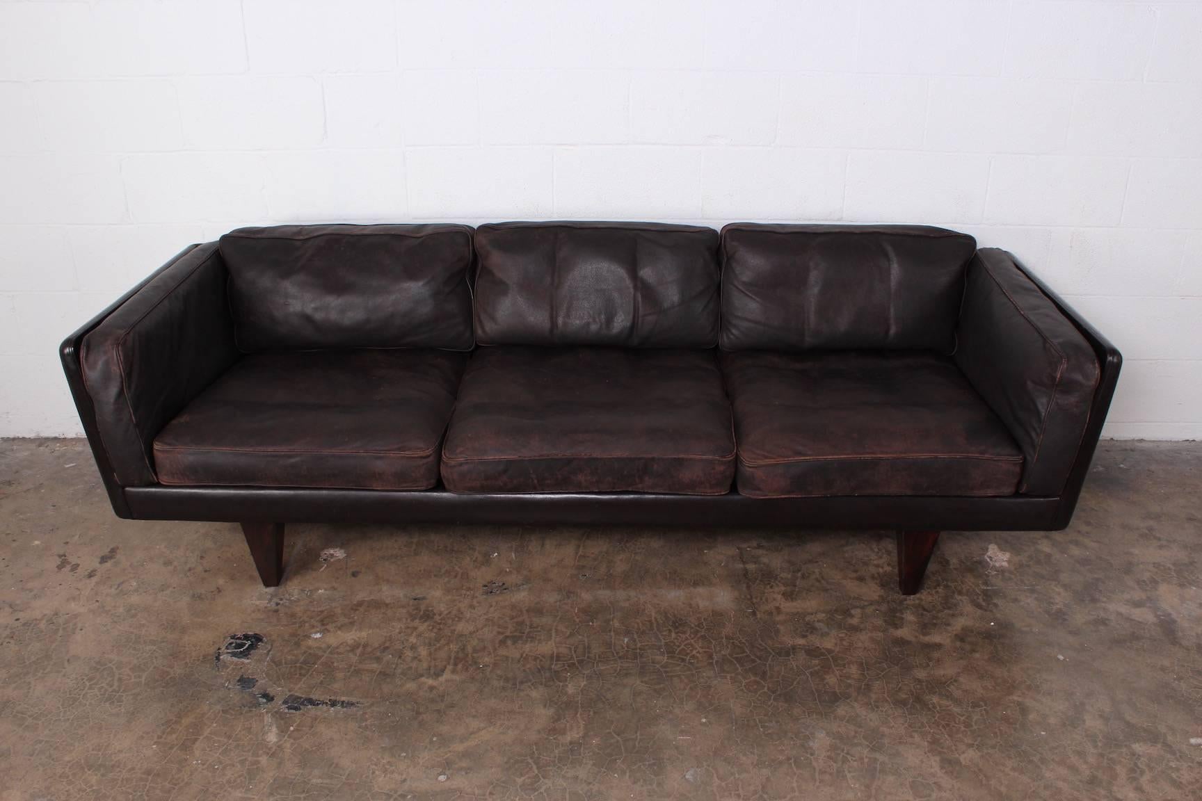 V11 sofa in original leather with full down cushions. Designed by Illum Wikkelsø. Very comfortable with heavy patina.
 