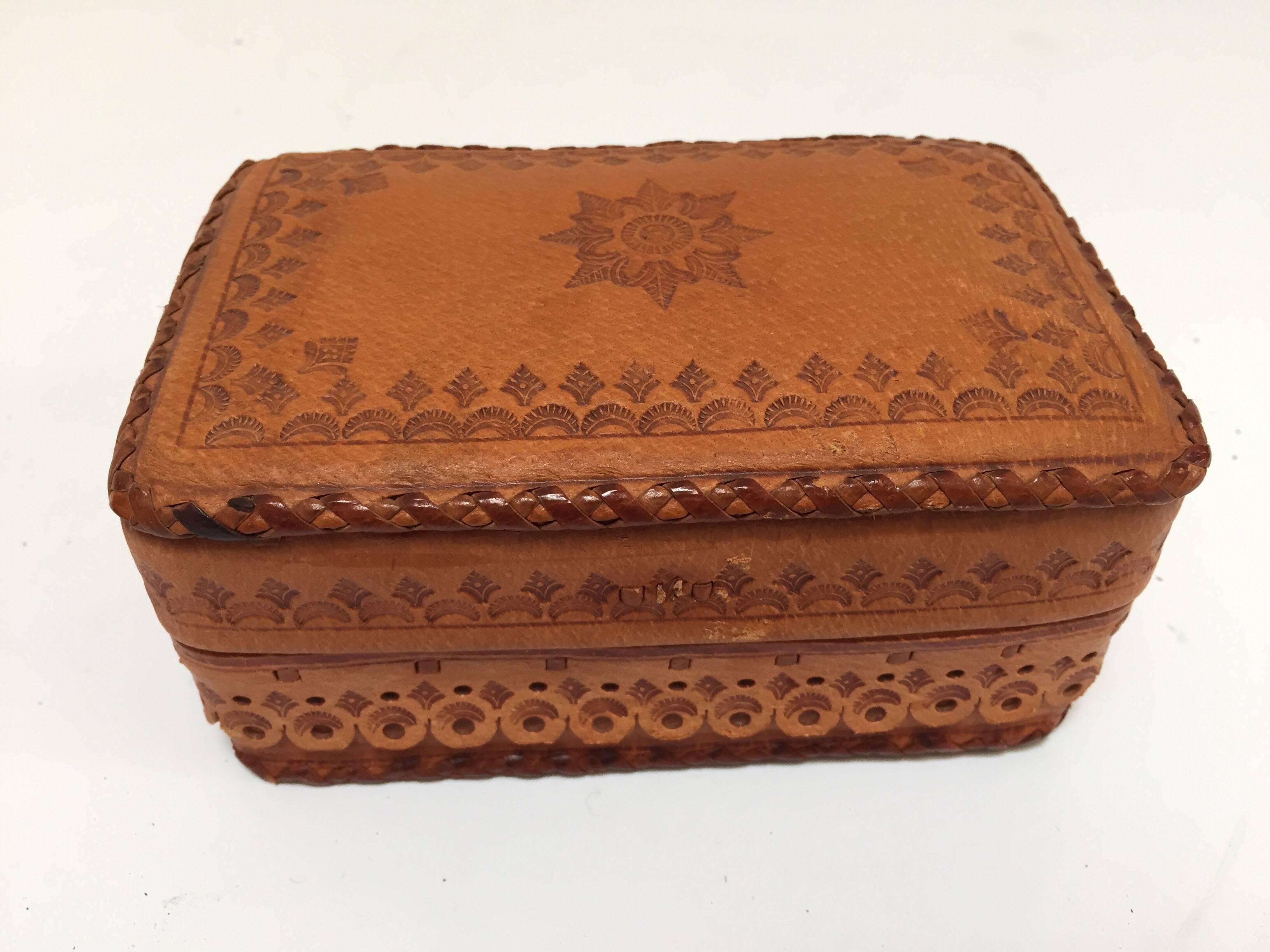 Hand tooled vintage leather box from Morocco camel color stamped with darker brown.
The workmanship of this piece is very fine, hand stamped and sewn with leather by the Berber tribes of Morocco.
Beautifully handcrafted and designed with classic