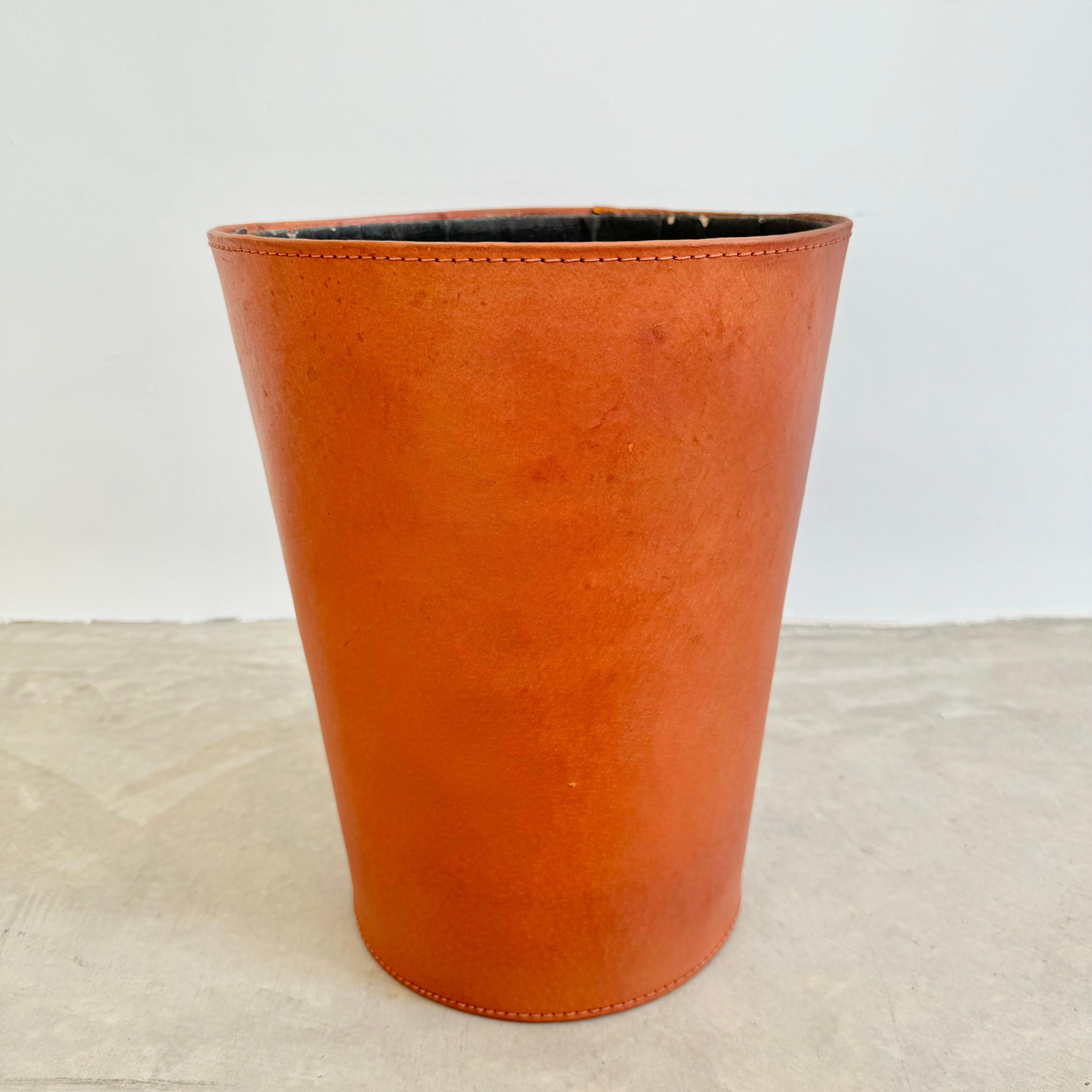 Handsome large leather waste bin in a slight conical shape. Circa 1950s. Beautiful tanned leather cowhide with great age and patina. Wear as shown. Good vintage condition. 

Located at our Los Angeles showroom.