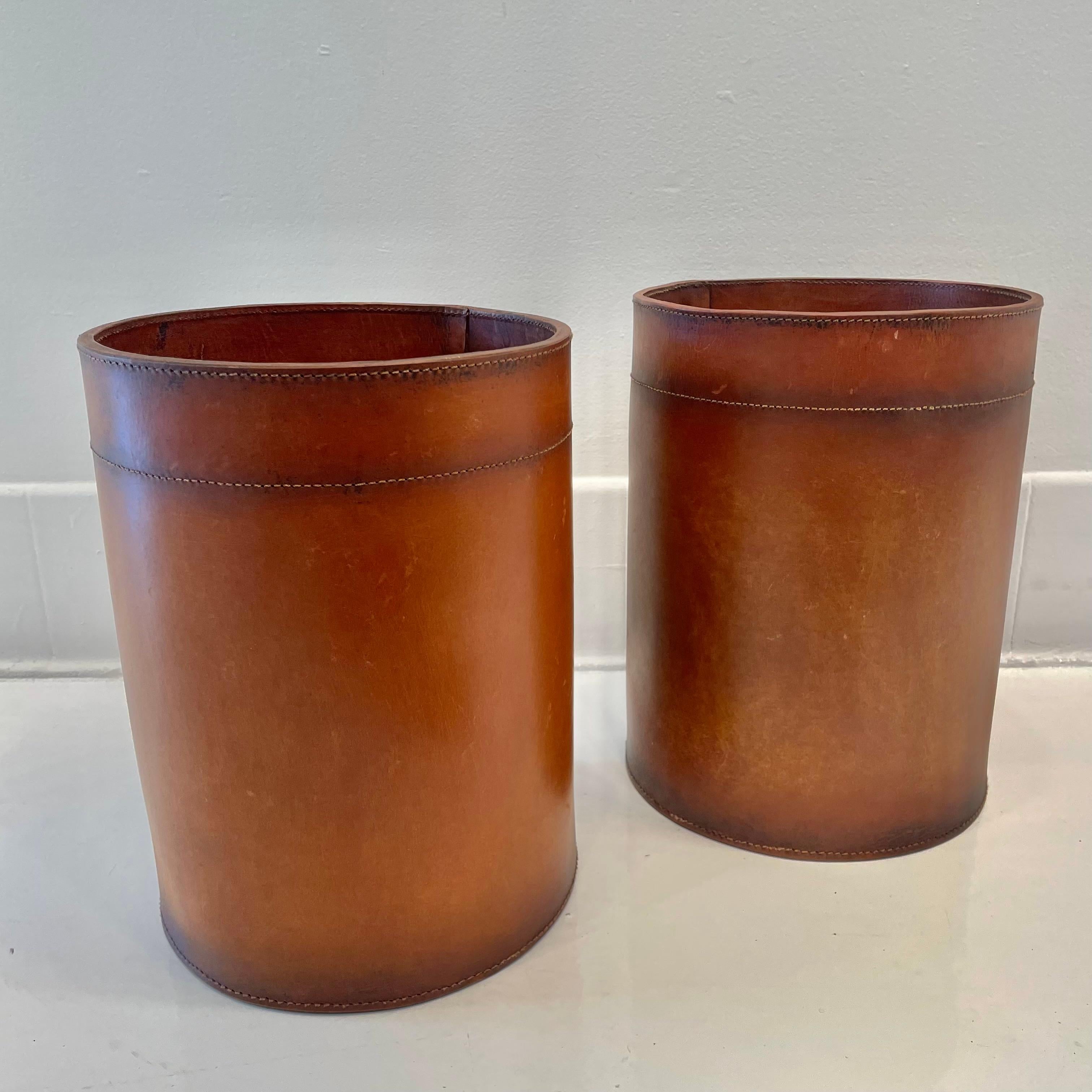 Beautiful leather waste bin in the style of Jacques Adnet produced by Merit Los Angeles. Made entirely of a thick cowhide leather in a distressed saddle color. High quality leather patina'd and aged by leather artisans. 3-4 week lead time. Priced