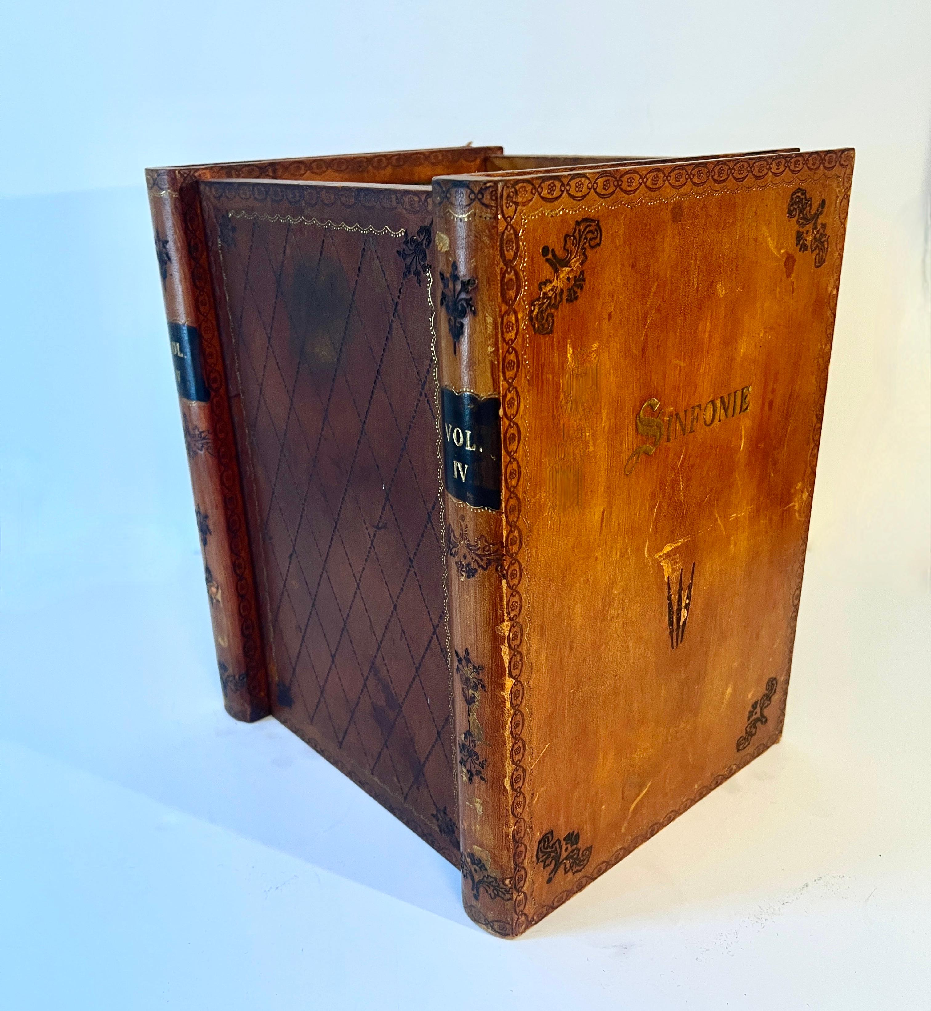 A very patinated Leather waste bin / can that is cleverly disguised as having leather bound Books.  The piece is wonderful and lined with a decorative paper.

We are not certain of the age, however it is likely quite old, but in very good structural