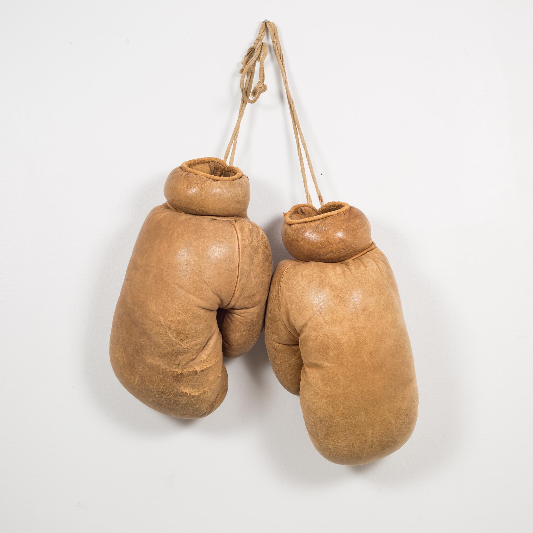 About

This is a original pair of Wilson leather boxing gloves. The boxing gloves are brown leather with brown leather piping. 