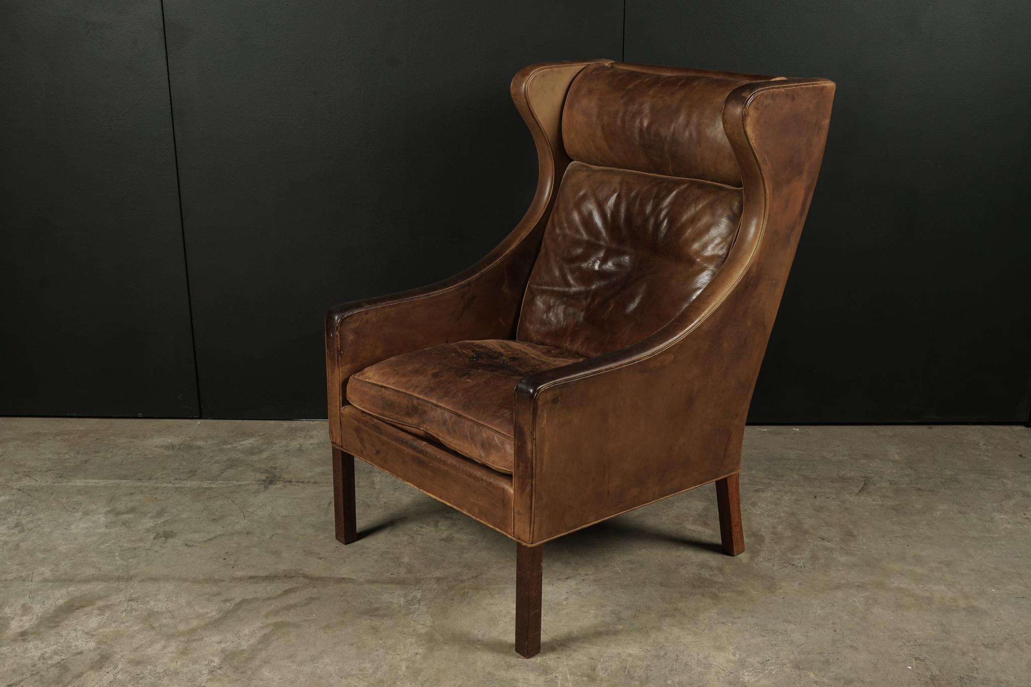 Leather wingback chair designed by Borge Mogensen, Model 2204. Fantastic patina and wear on leather. Manufactured by Fredericia Stolefabrik, Denmark.