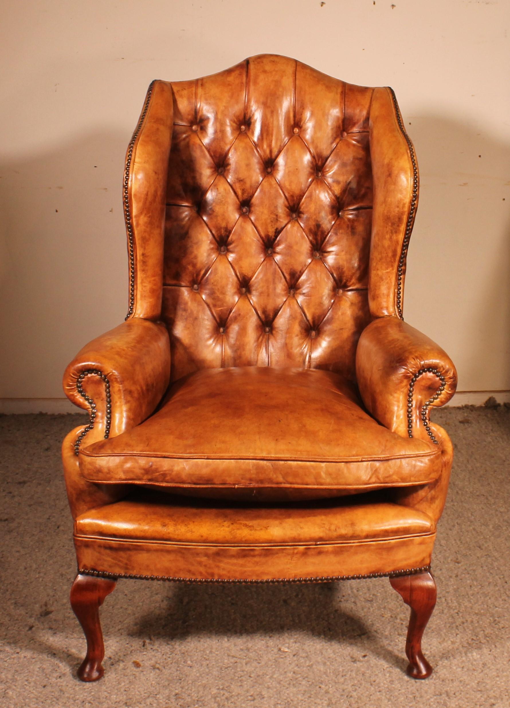 superb wing chair called Queen Anne in cognac-coloured leather from England

Very beautiful model resting on a mahogany base.
We had it re-strapped by our upholsterer 
It is rare to find a leather armchair that has such a beautiful patina