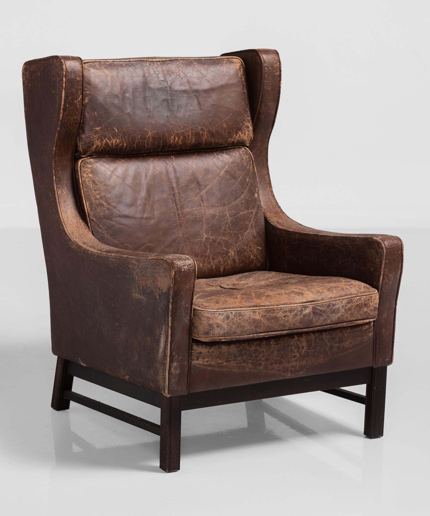 Leather wingback armchair, Denmark, circa 1960.

Generously sized in original leather.
