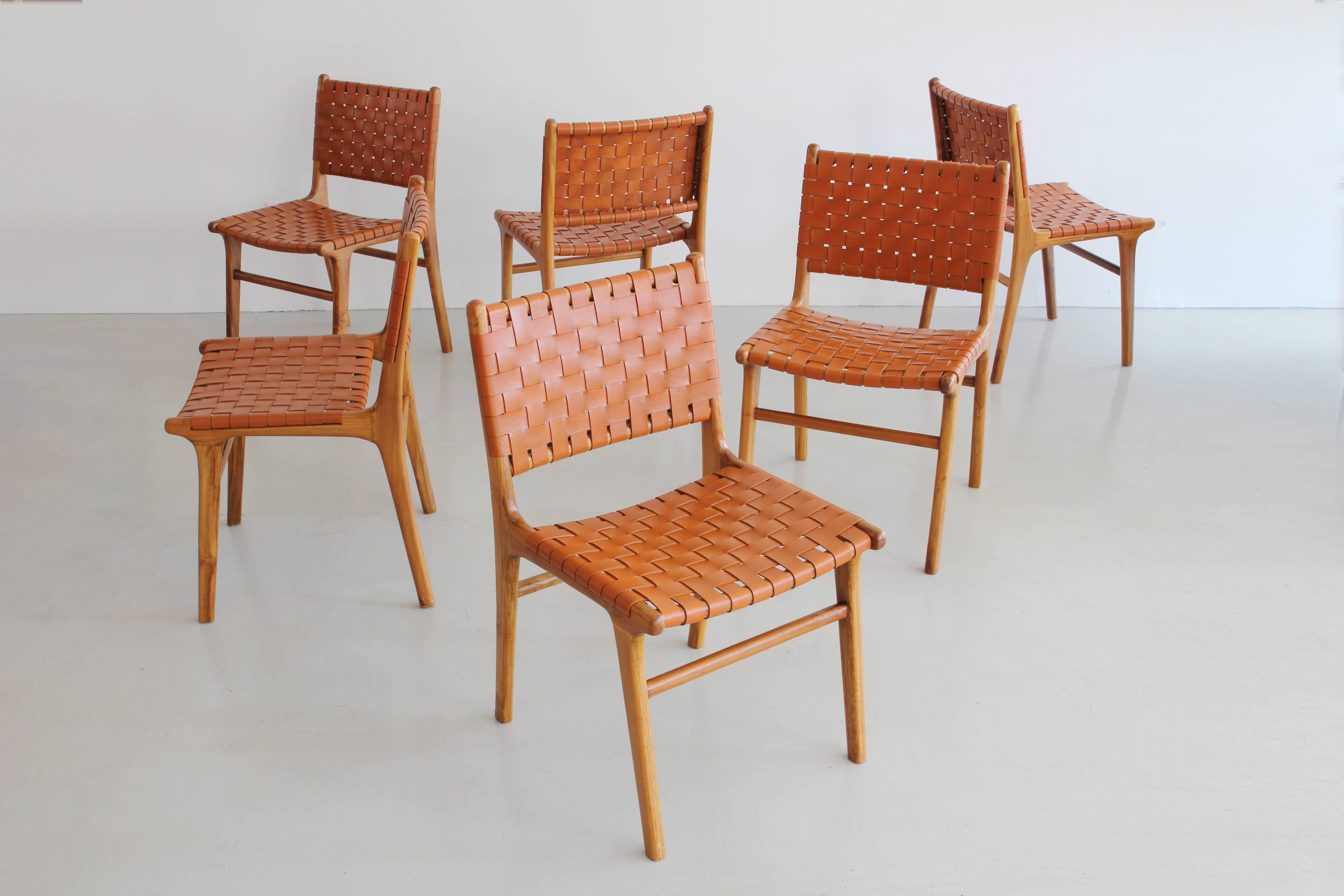 Set of six beautiful woven leather chairs in caramel leather and wood base with angled legs.