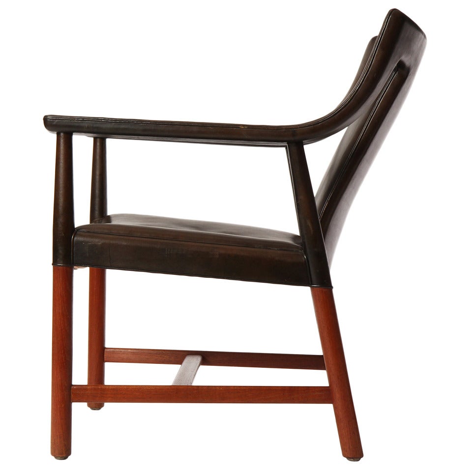 A Scandinavian Modern armchair by Ludvig Pontopiddan. This chair features exposed teak legs with the arms, back and seat all wrapped in smooth black leather. Made in Denmark, circa 1950s.

Following in the footsteps of his father, Ludvig