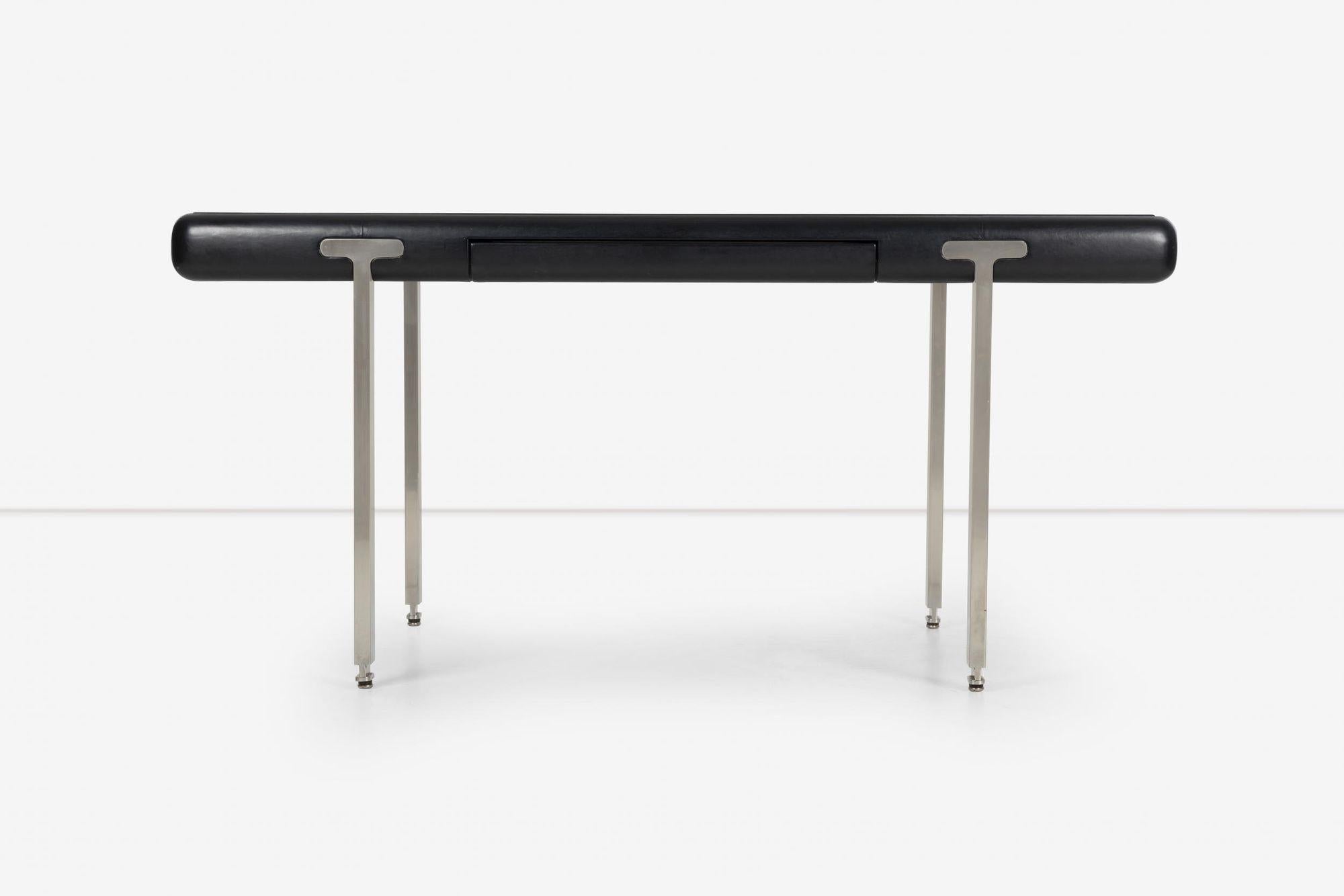 Leather wrapped desk John Mascheroni Style on Steel Mounted DeskCirca 1970
with one central pencil drawer, on T supports.
Property from a David Collins-Designed New York Residence
Dimensions:
Height 28 3/4 inches x width 71 1/2 inches x depth 36