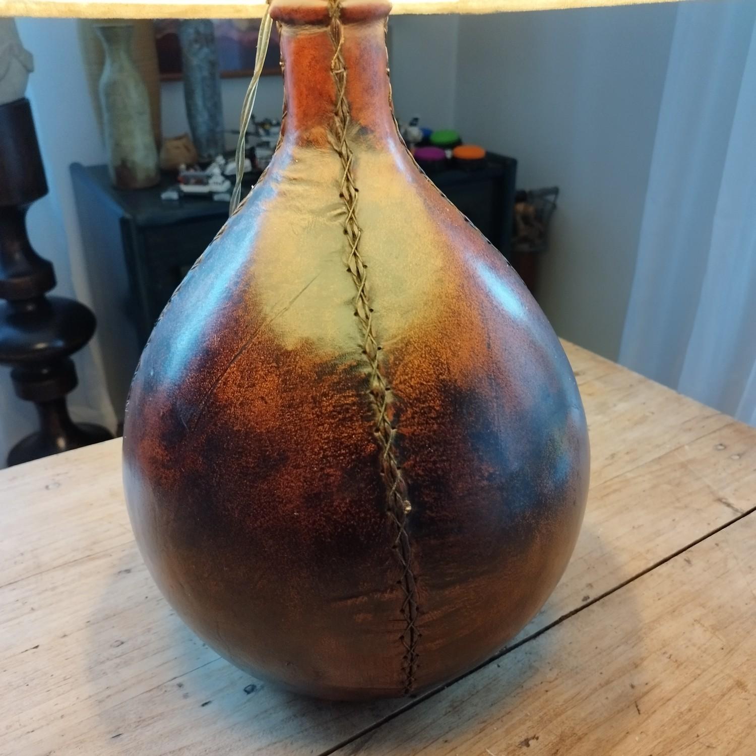 Leather wrapped glass bottle mounted into a lamp, 1970's.
Do not hesitate to ask me for a shipping quote.