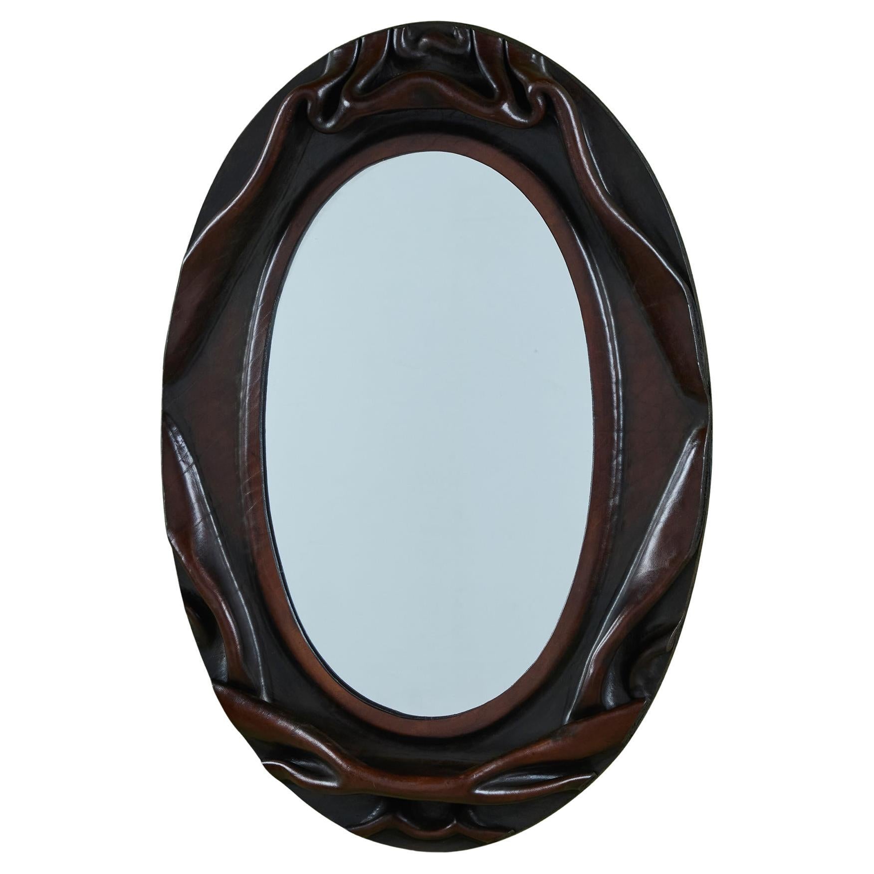 Miroir mural ovale gainé de cuir