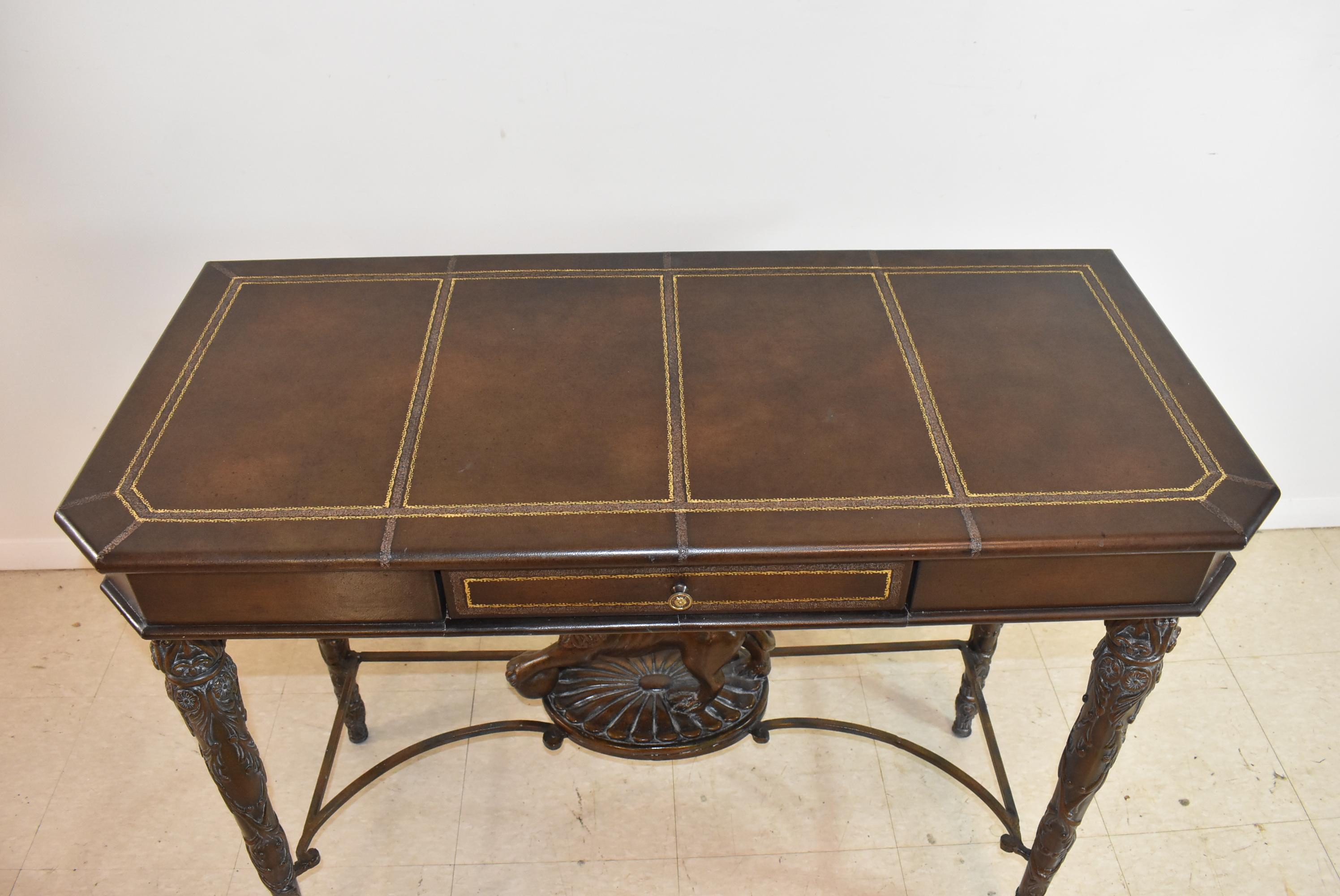 Leather wrapped writing table with lion, Maitland Smith style. Mahogany table, could be used as a writing table, side table, or console table; 40