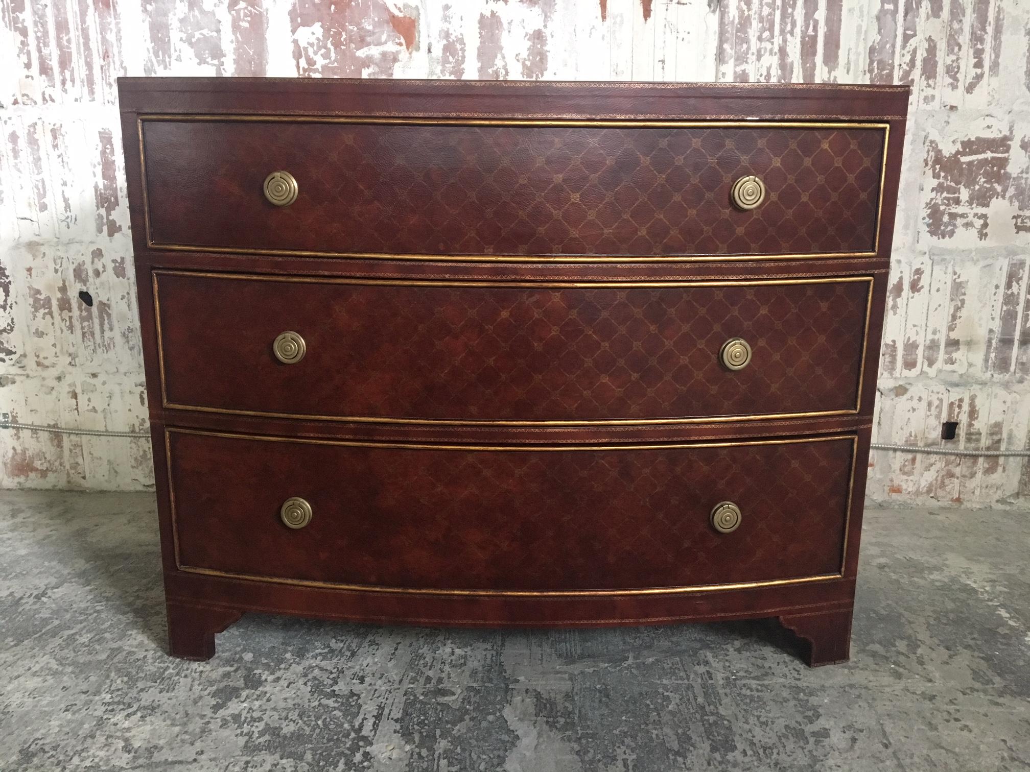 Three-drawer dresser by Ferguson Copeland, Ltd. features leather-wrapped finish accented with brass detailing and brass hardware. Good vintage condition, minor signs of use appropriate with age.