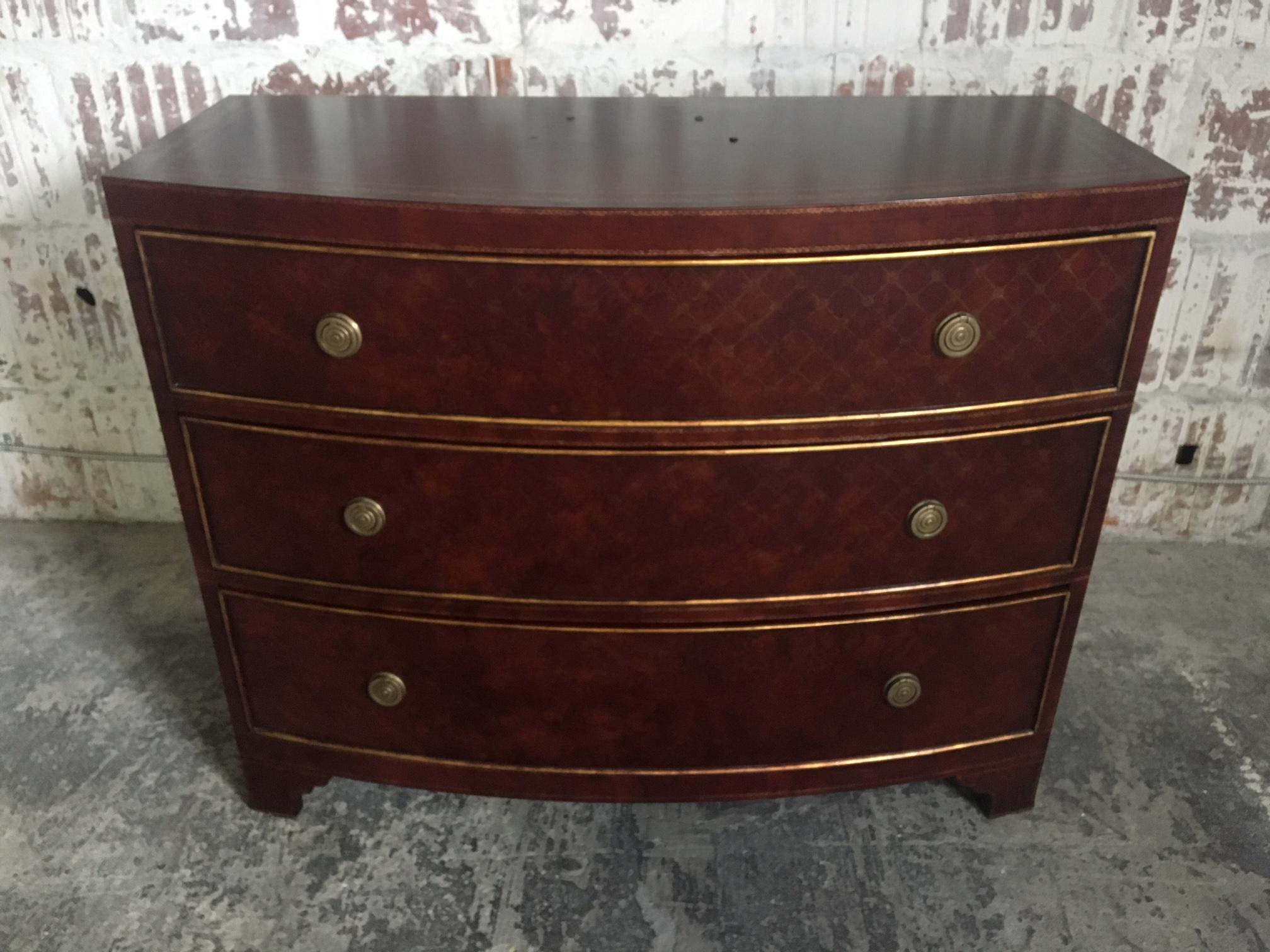 Three-drawer dresser by Ferguson Copeland, Ltd. features leather-wrapped finish accented with brass detailing and brass hardware. Good vintage condition, minor signs of use appropriate with age.