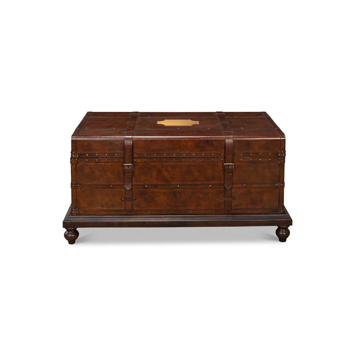 In a tobacco finish with brass nailhead details, leather belt clasps raised on a wooden base.

Dimensions: 43