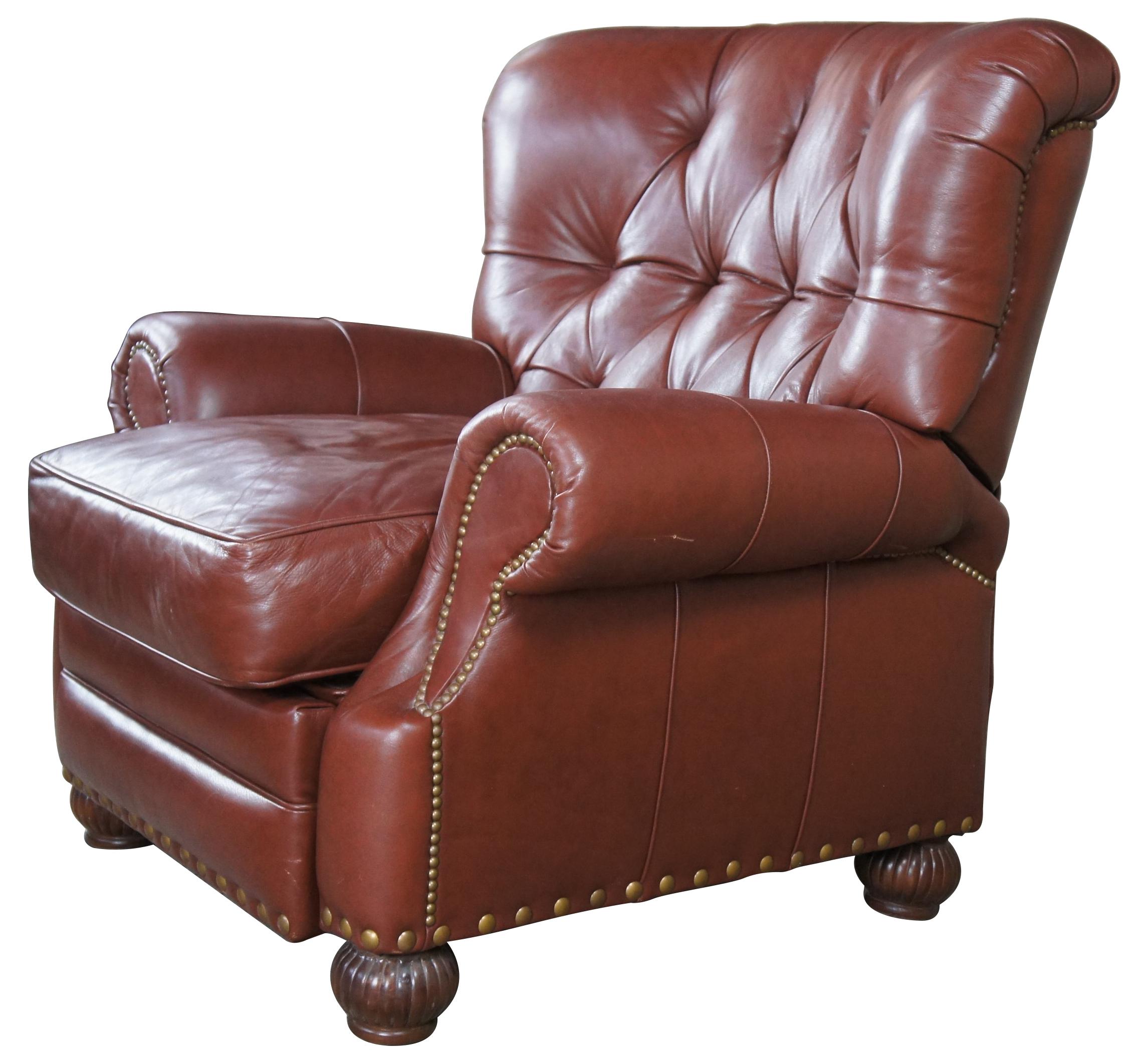 Vintage Leathercraft, Inc Traditional Chesterfield Wingback Recliner.  Features a tufted back of chestnut leather and nailhead trim.  The chair is supported by ribbed bun feet.  #89379-050, upholstery Sarato Chestnut, 26-916.

Leathercraft Inc is