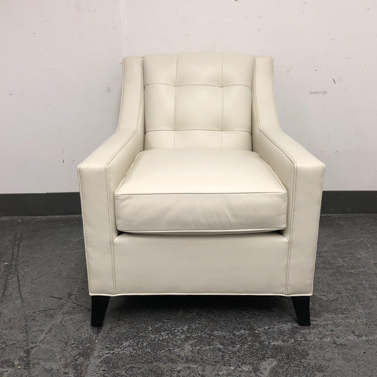 An accent Leather lounge chair in style 112. Upholstered in an grade two maxima Iceberg 3943 leather. Leg finish is #10 Ebony and accented with a #9 nailhead trim polished nickel. Includes a tufted back. Measures: Arm height 24 inches, seat height