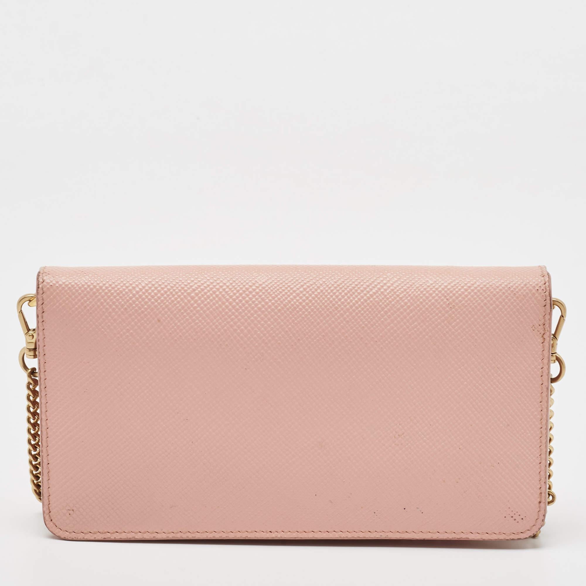 Crafted in Italy, this Prada WOC is made from Saffiano Cuir leather and comes in pink. It has a front flap with the signature detail and it opens to a lined interior. The bag is equipped with a shoulder chain in gold-tone.

Includes: Authenticity